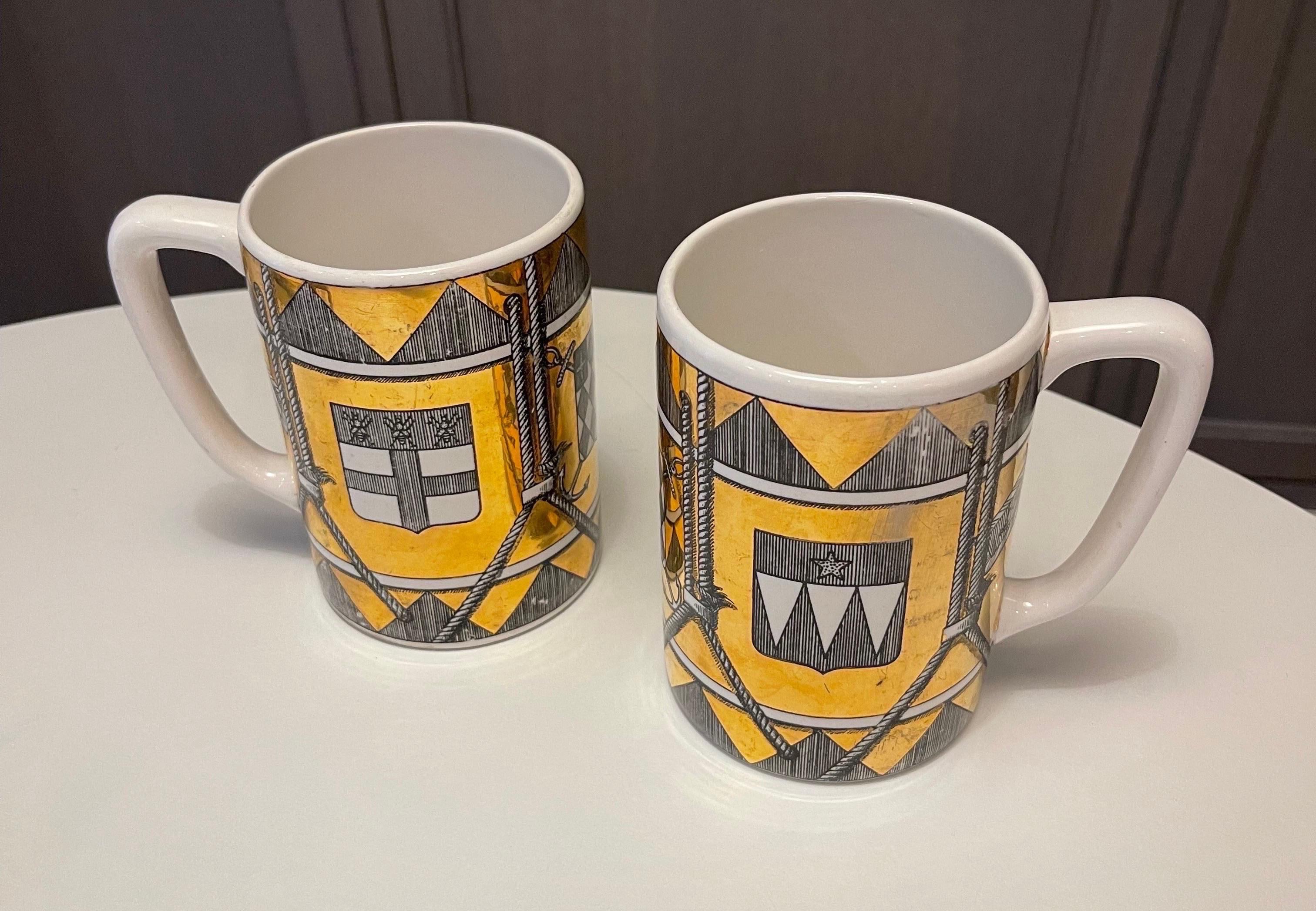 Pair of beer steins by Piero Fornasetti from the 1950s, never reissued and relatively rare. Crest/rope/nautical/seafaring motifs. Pictured in Fornasetti’s Complete Universe book, the closest thing this designer has to a raisonne, on p. 579. See