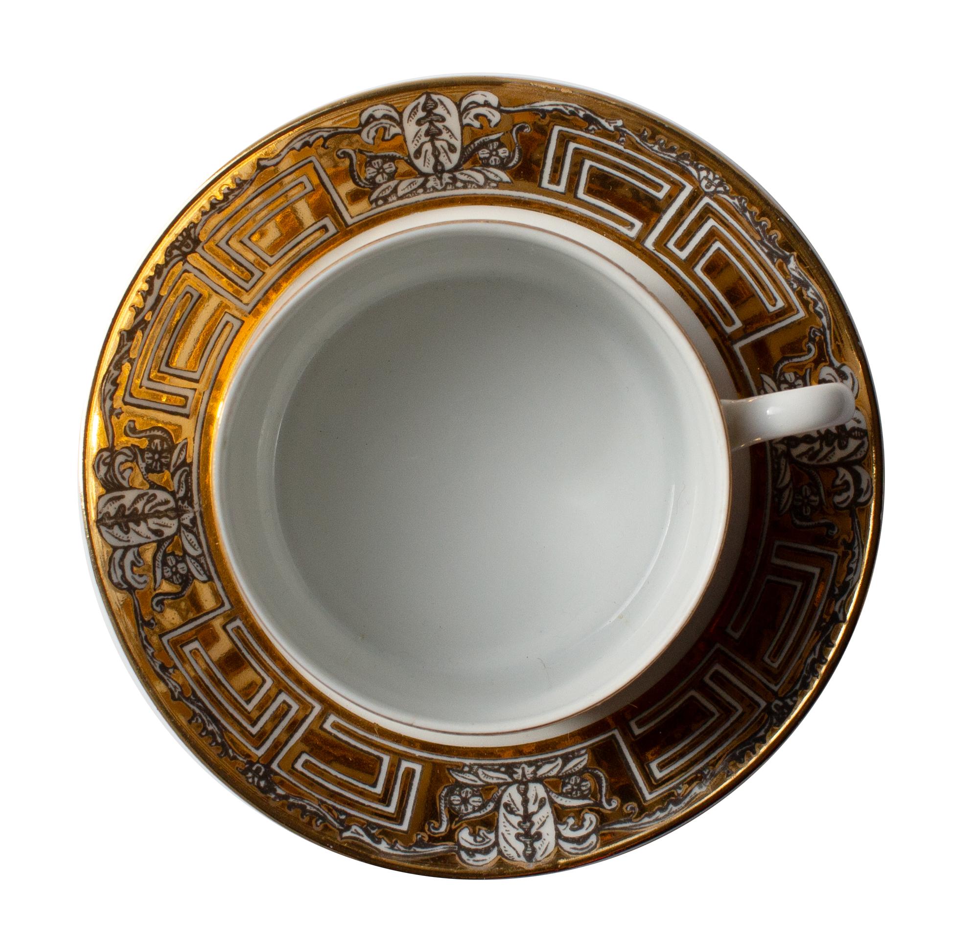 An early pair of porcelain cups with saucers, designed by Piero Fornasetti (1913–1988) in Milan, circa 1955.
The model “Greca” is decorated with a black and gilt neoclassical key motif, a recurring theme in Fornasetti’s mid-century production. Both