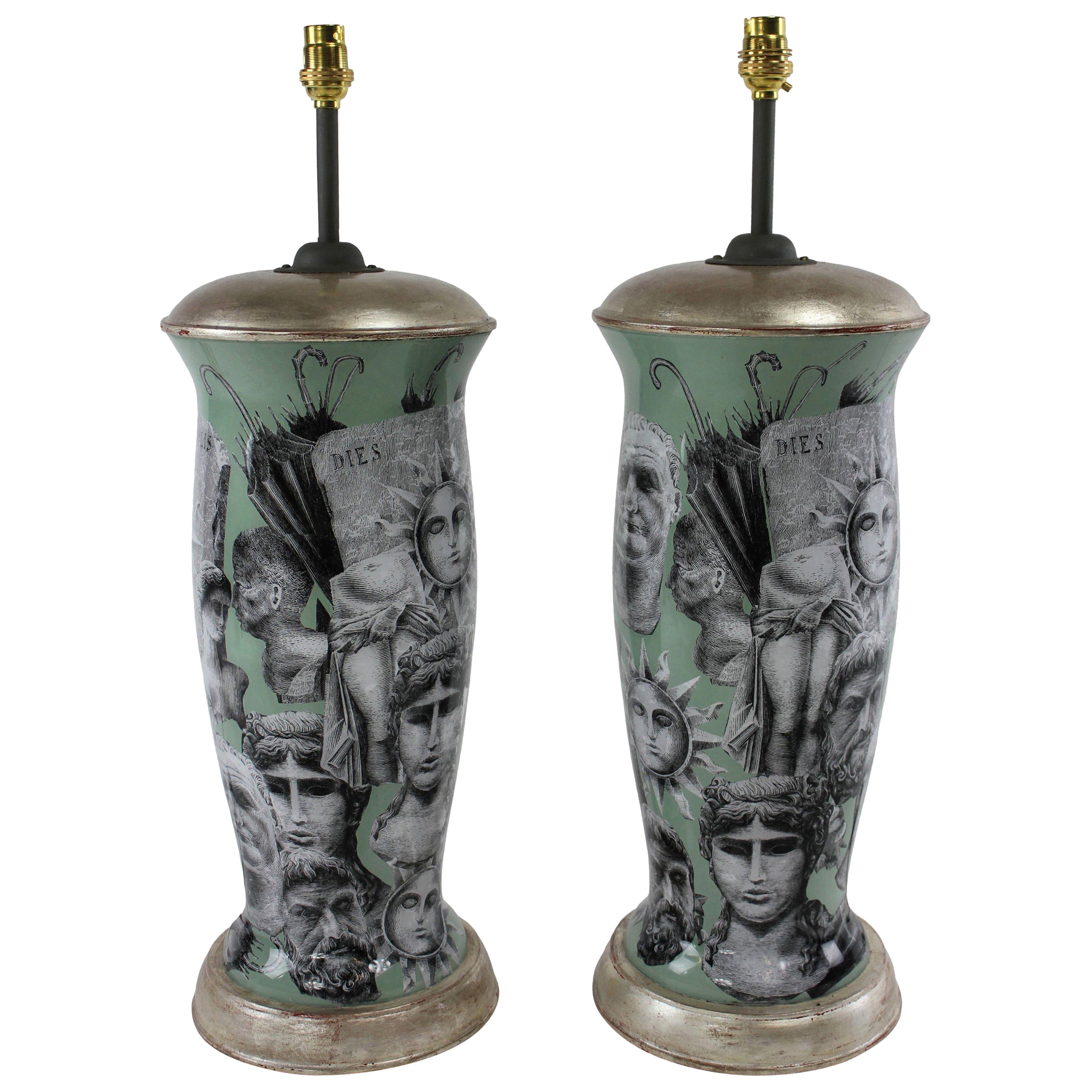 A pair of declamania hand painted table lamps inspired by the designs of Pietro Fornasetti. With white gold leaf tops and bases.