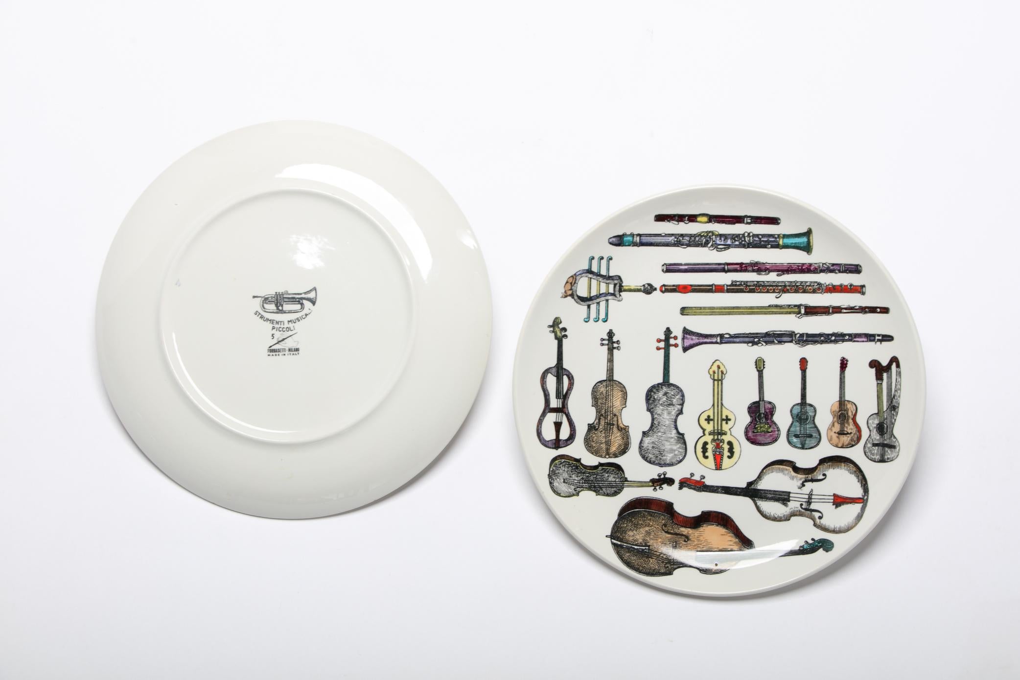 Porcelain Pair of Italian Fornasetti Musical Instrument Themed Plates For Sale