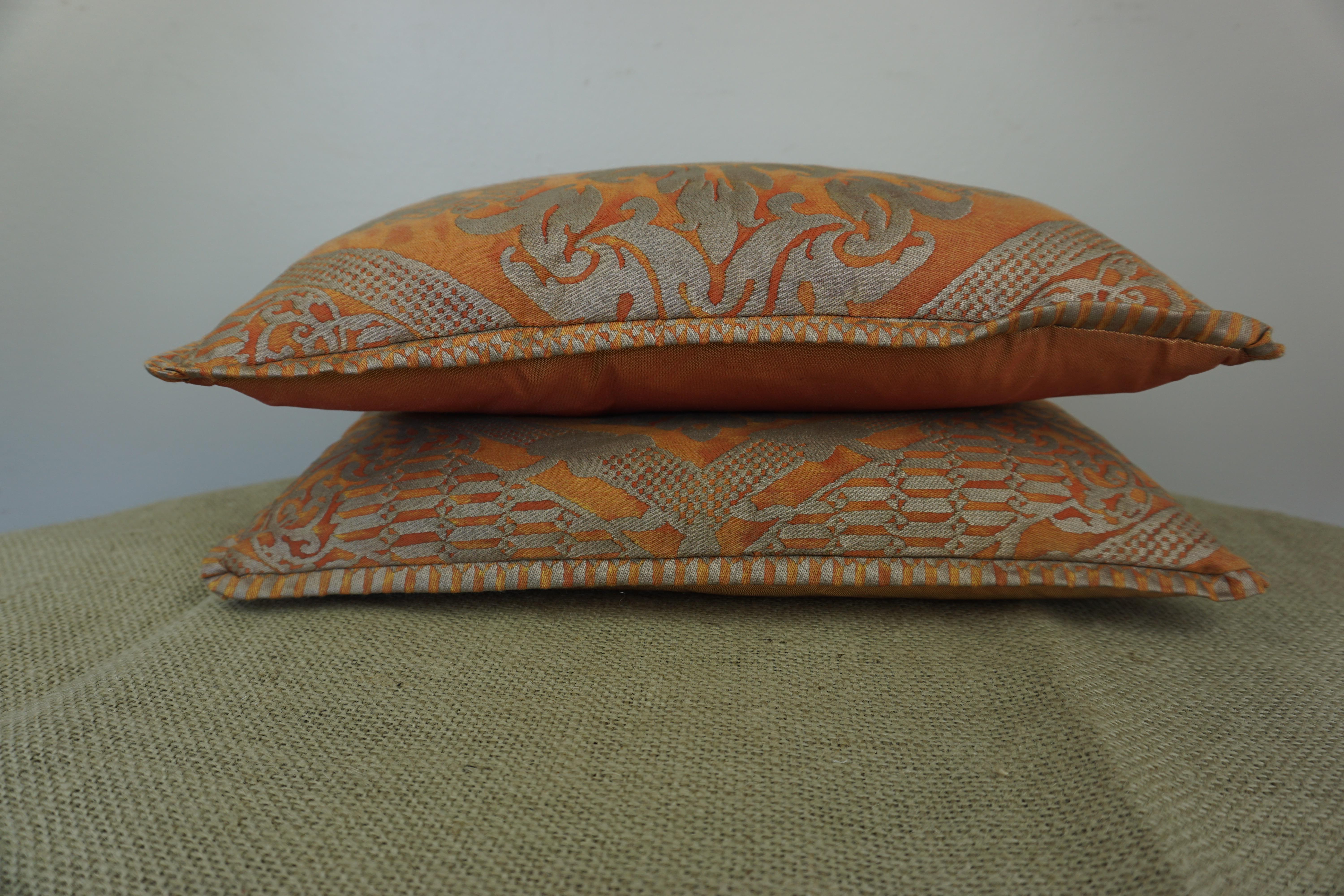 Pair of custom accent pillows made with bittersweet & silvery gold colored cotton Fortuny fronts and vibrant silk backs. Down inserts, zipper closures.