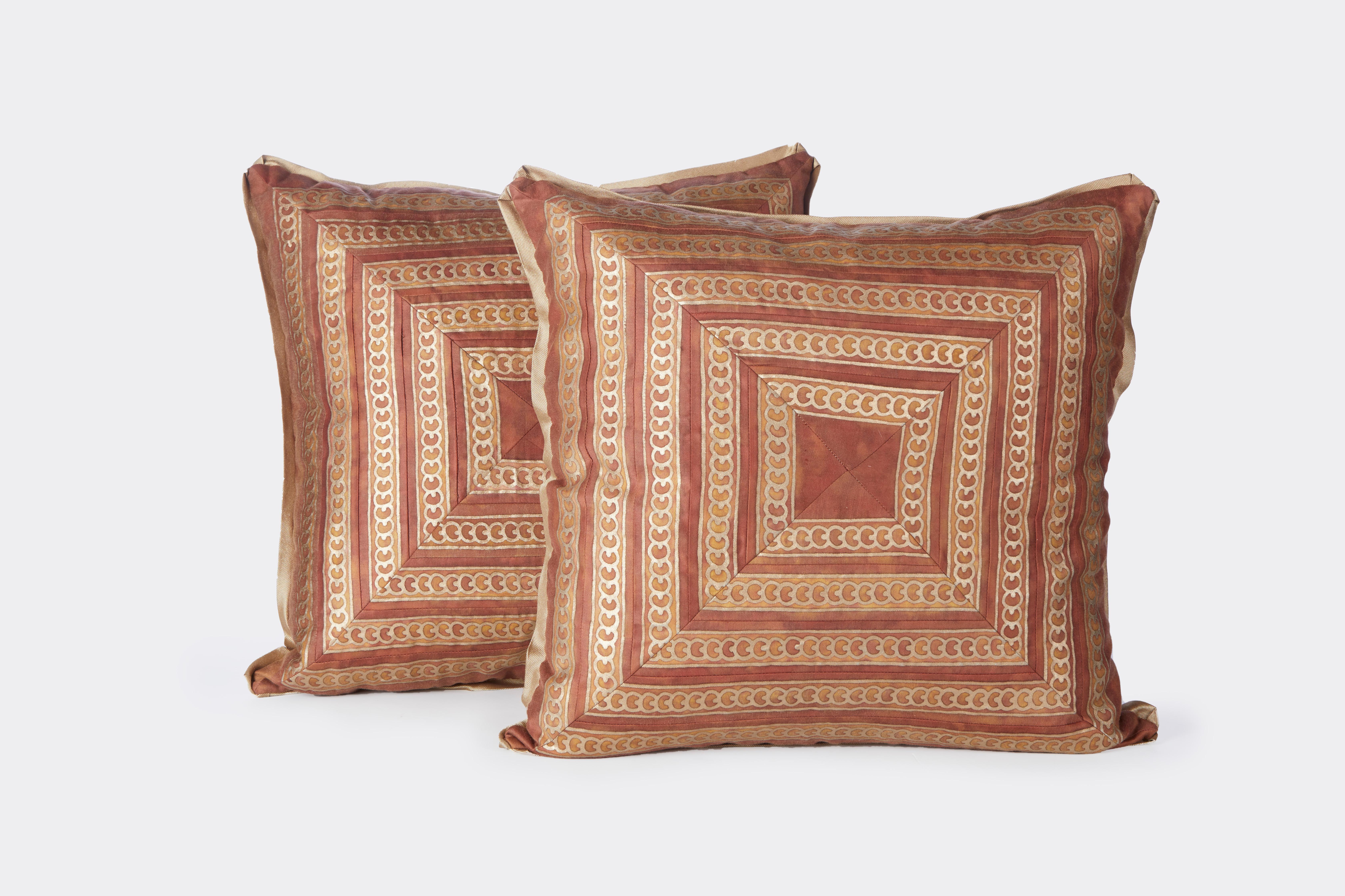 Pair of square cushions the pillow faces created with vintage Fortuny fabric borders pieced and mitered. Trimmed with silk bias edging and having silk fabric back.
50 down/50 feather insert.
All sales are final 