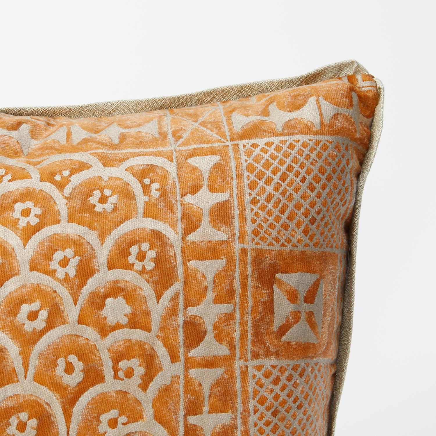 A pair of Fortuny fabric cushions in the Ashanti pattern, burnt apricot and silvery gold color way with silk edging. Wool fabric with brushed texture backing. The pattern, a Geometric design with African tribal motif. 

50 down/50 feather insert.