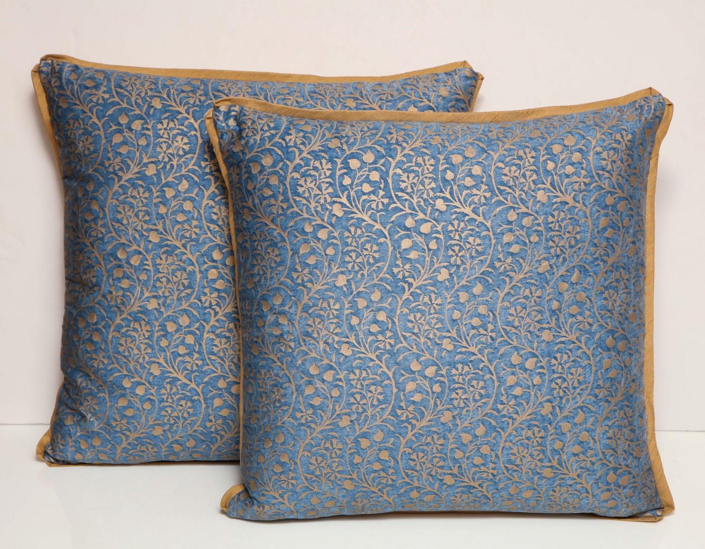 A pair of Fortuny fabric cushions in the Granada pattern, blue and silvery gold colorway with beige backing material, the pattern, a modern Spanish design named for the birthplace of Mariano Fortuny in Granada, Spain 
50 down/50 feather