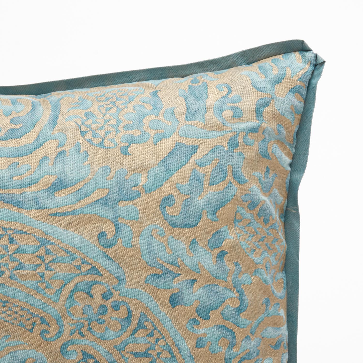 A Fortuny fabric cushions in the Orsini pattern. Featuring a gorgeous gold and blue colorway, the Orsini pattern is a 17th century Italian design named for one of the most princely families in medieval Italy and Renaissance Rome, the Orsini. With