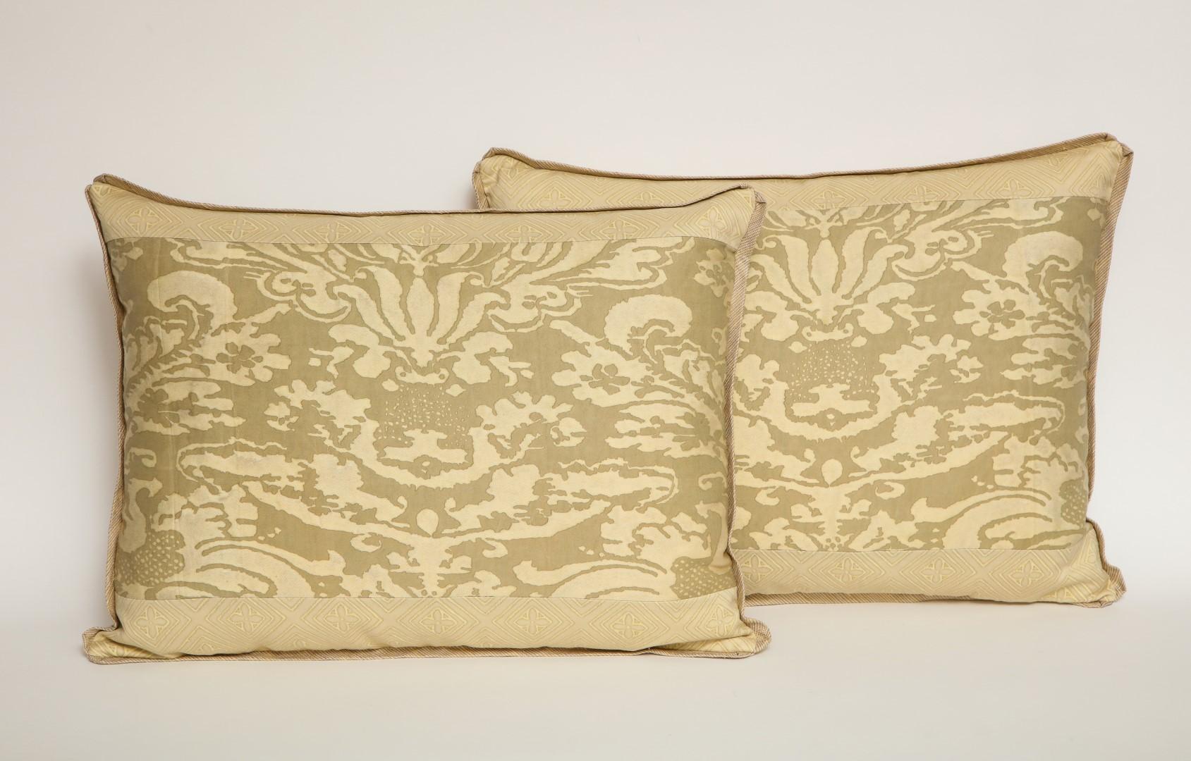 A pair of mitered Fortuny fabric lumbar cushions in the Lucrezia pattern, green and beige color way with silk bias edging, the border in the Jupon pattern.
50 down/50 feather insert.
Newly made.
   
