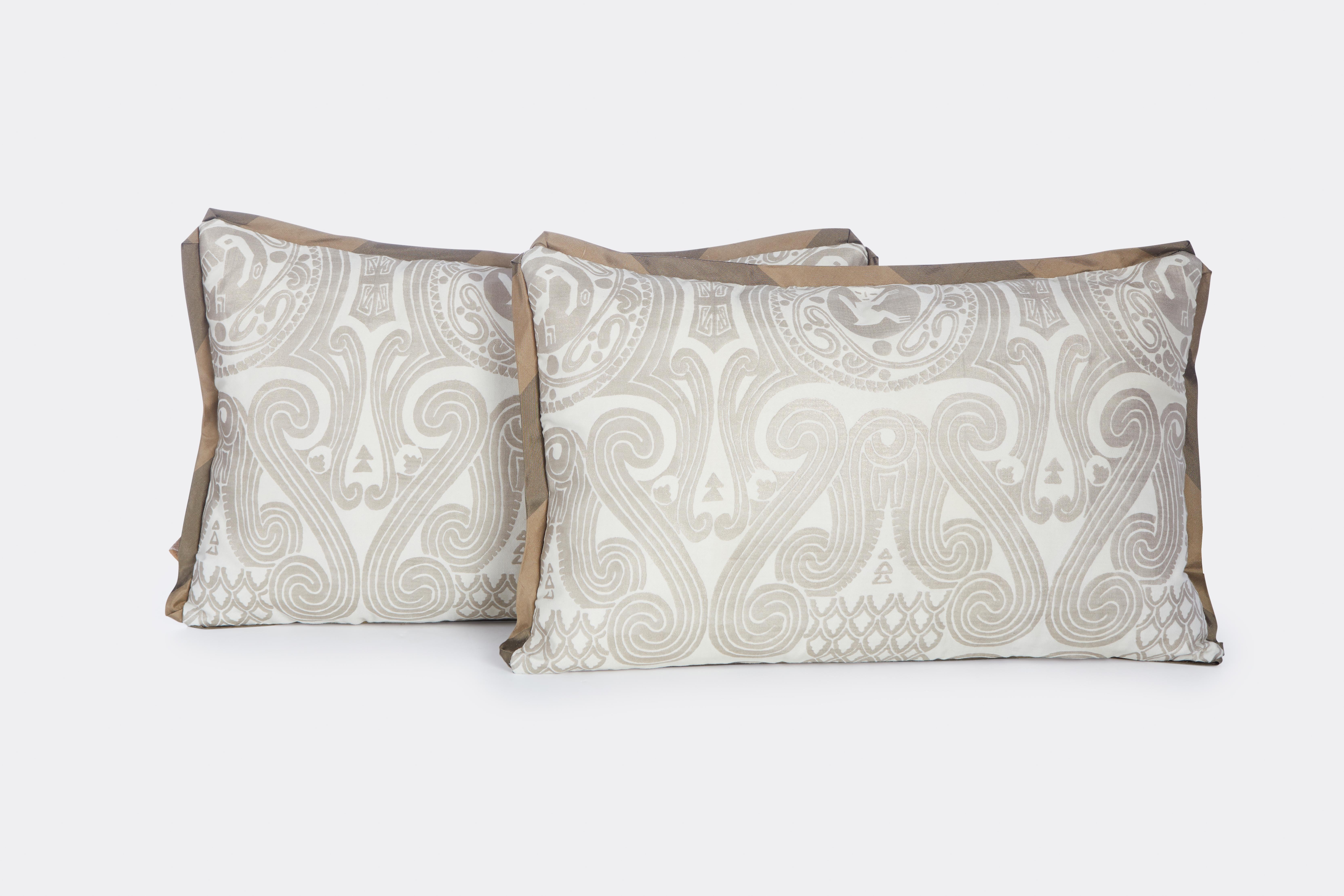 A pair of Fortuny Peruviano cushions ion silvery gold on white with striped bias edging and linen blend back.