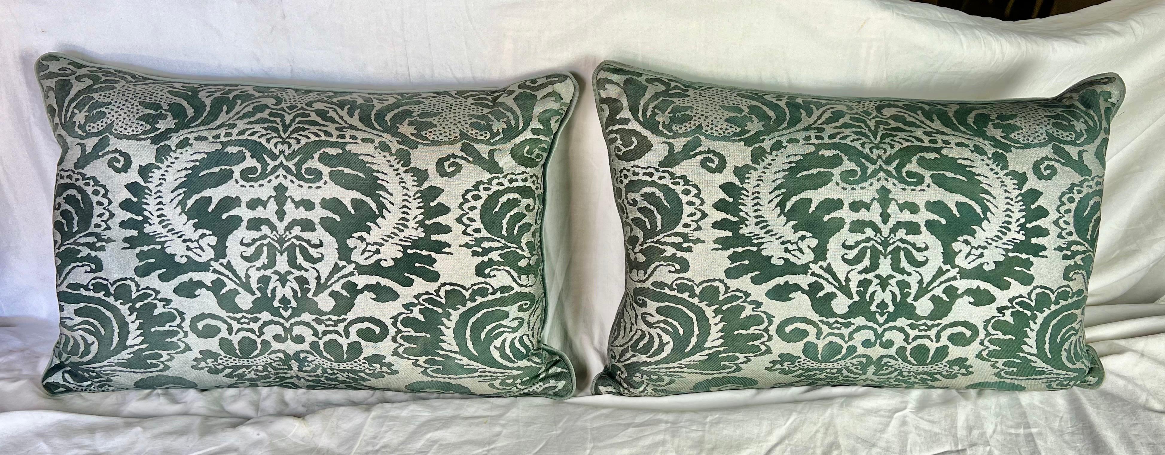 A sophisticated and unique pair of Fortuny textile pillows with a touch of dark gray and green, complemented by gray velvet backs and down inserts.  They add a luxurious touch to any space.