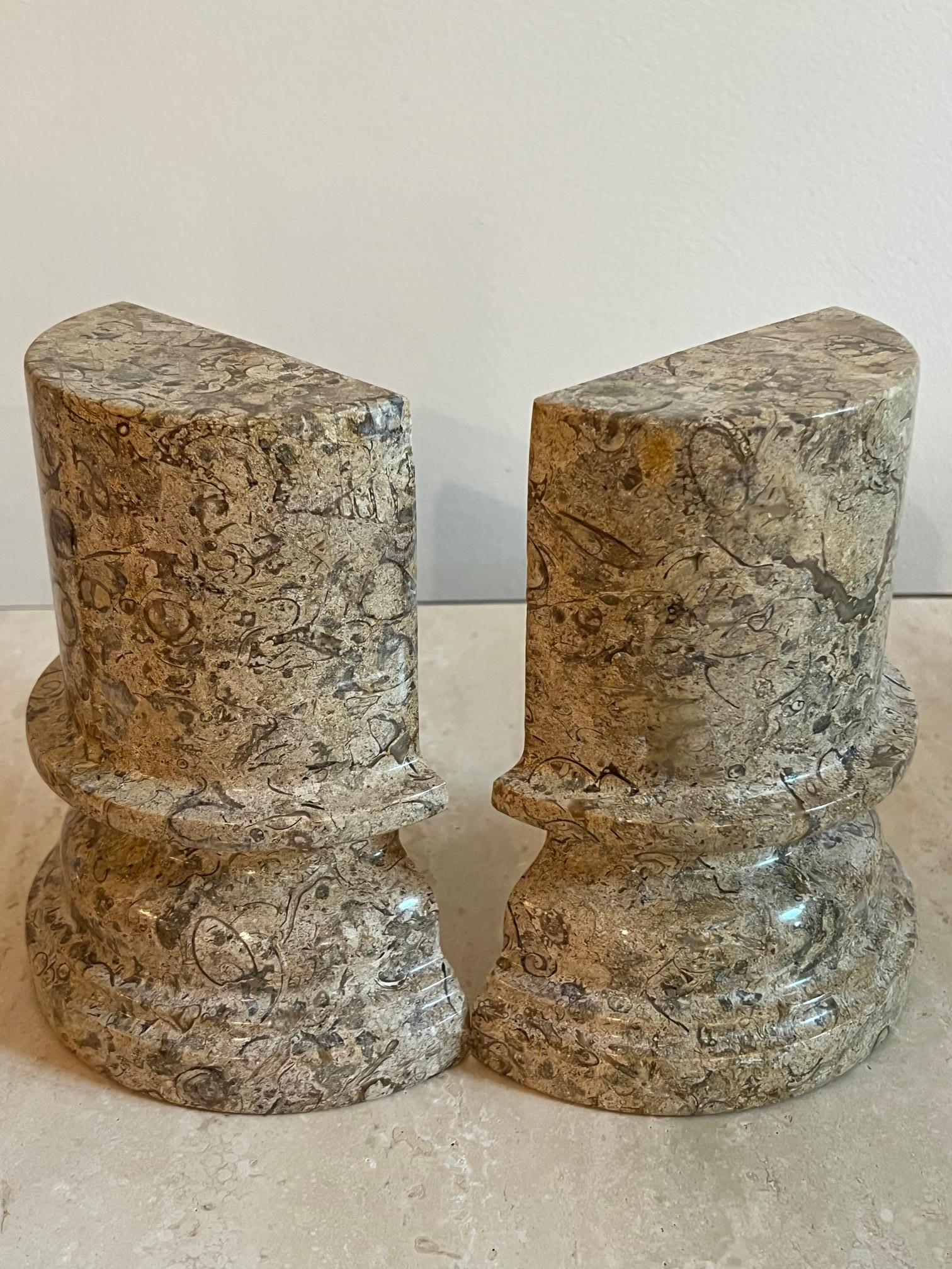 This pair of hand-carved bookends with fossilized shells embedded in solid stone makes for a chic addition to any bookcase or interior.  With natural neutral tones, suitable for an organic modern decor. 
Italy, circa, 1980’s
Size: 6 3/4