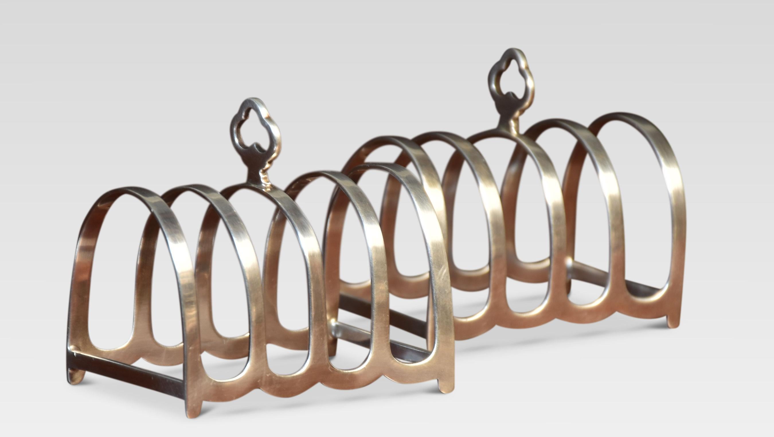 Pair of four division silver toast racks with trefoil hoop handles, stamped Chester 1932.
Dimensions
Height 3 Inches
Width 3 Inches
Depth 2 Inches