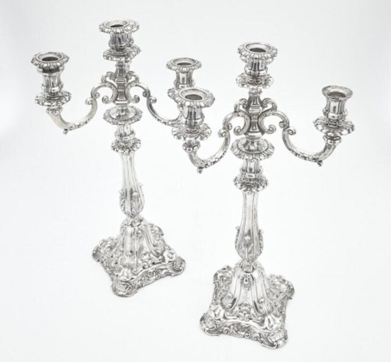 This ornate pair of candelabra from the 19th century measures 19 inches tall and 9 1/2 inches from arm to arm and is from continental Europe. The baluster stems from leaves. Has an engraving on its base and bears hallmarks, as shown in images.