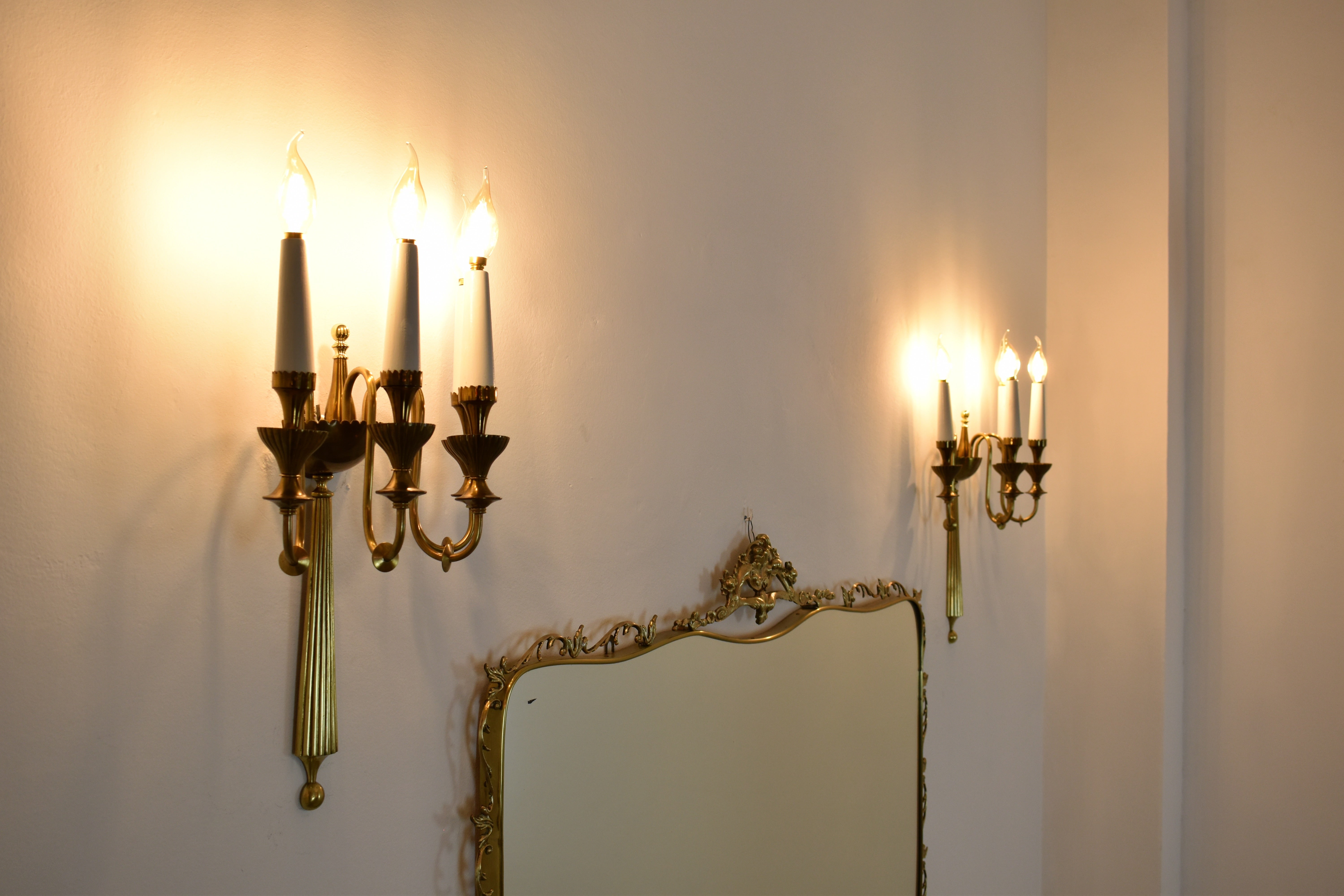 A stunning pair of wall sconces from the 1940s. Handcrafted in Italy and designed in the style of Fontana Arte, these brass fixtures feature a sophisticated structure with four lights. Fit e14 bulbs. 
--------------

Our Gallery
Spirit Gallery is a