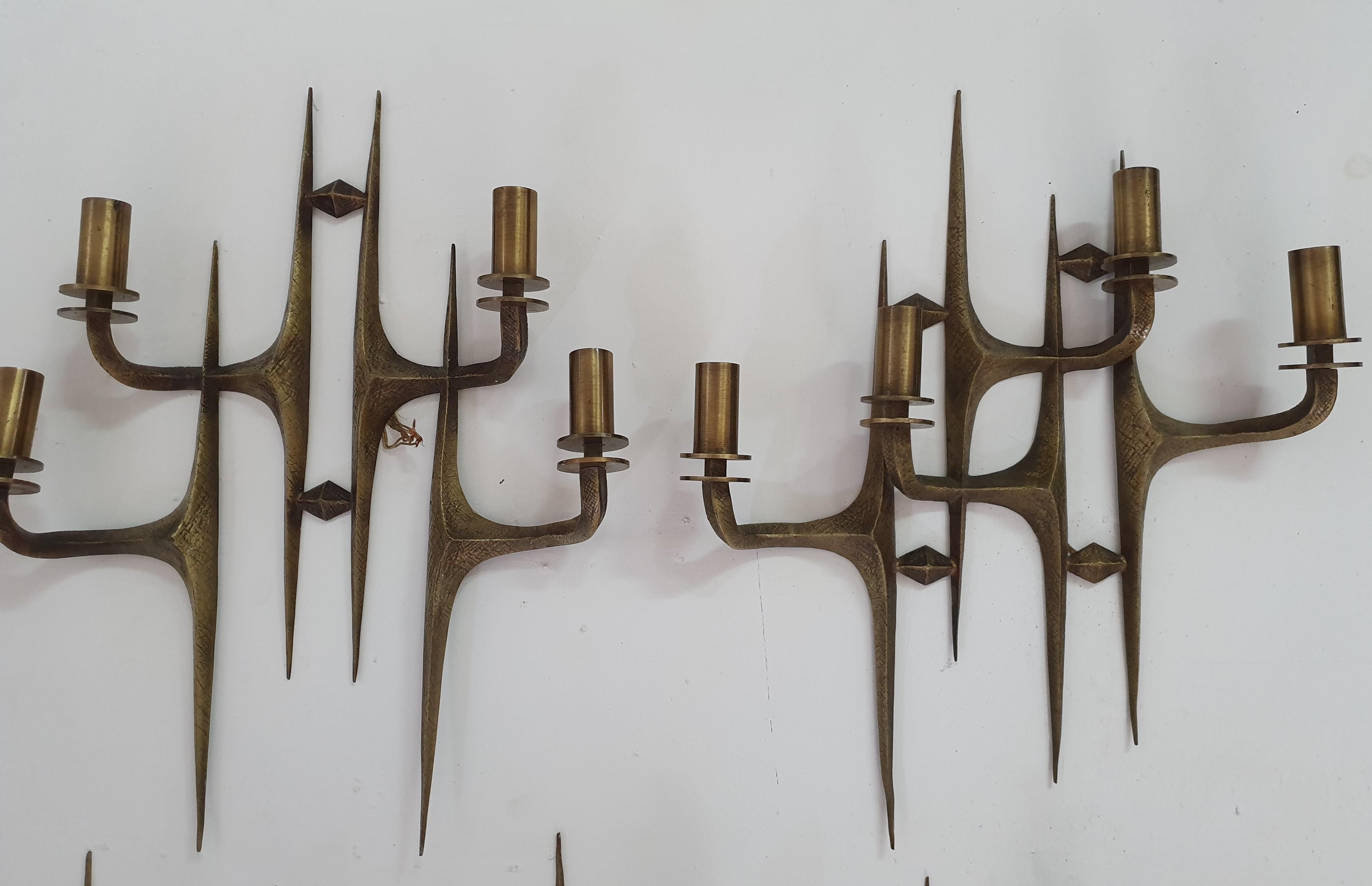 Mid-Century Modern Pair of 4-light brass sconces in the manner of Felix Agostini. Although not Identical, these are a pair and were part of a set of 6 together with 4 more 2-light sconces (already sold).
They all came from the same Villa in