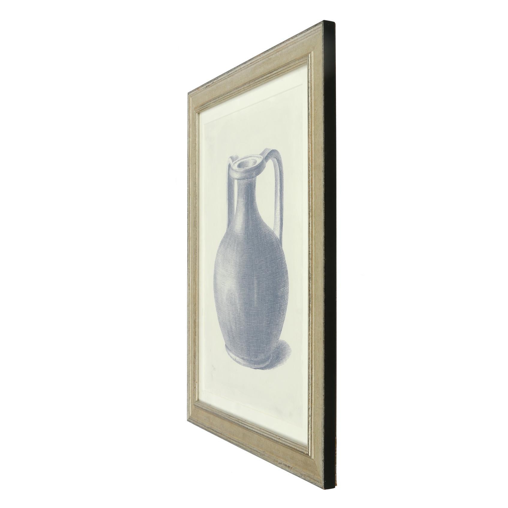 A pair of decorative numbered prints of urns in a beautiful indigo color in silvered wood frames.