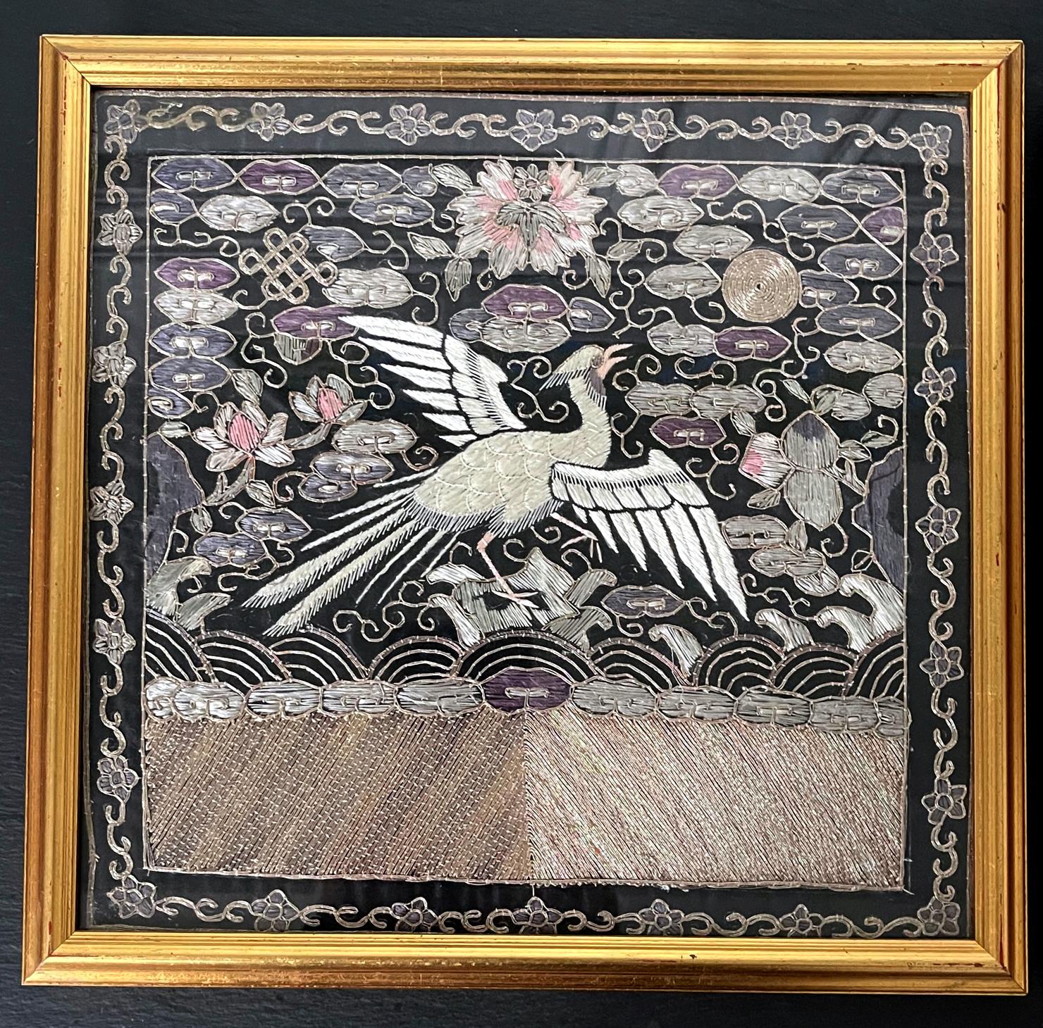 On offer is a matching pair of embroidered silk civil rank badge panels (known in Chinese as Buzi) in black lacquer frames. The panels feature a black background within a scrolling floral border. In the center, it showcases a winged paradise fly