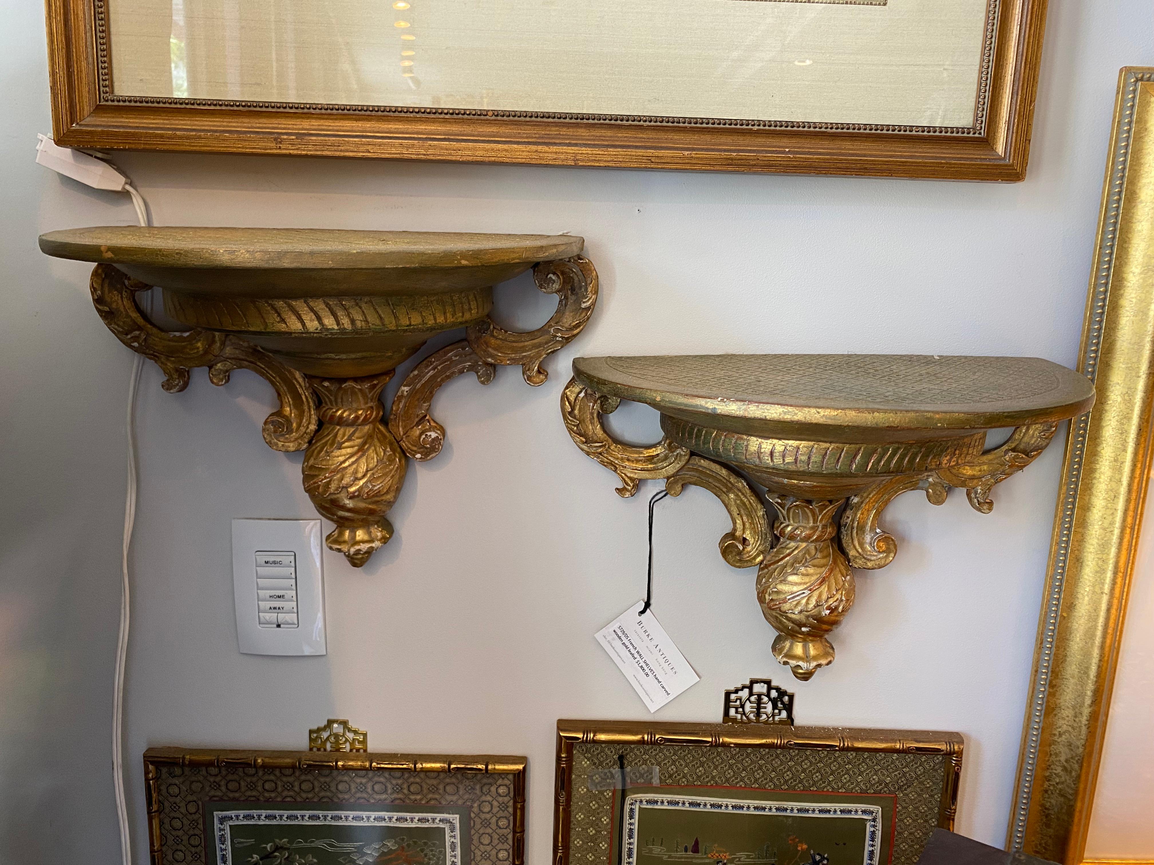 The Pair of gold Gilt wooden wall sconces are a delight hand carved having several levels making a eye catching design.