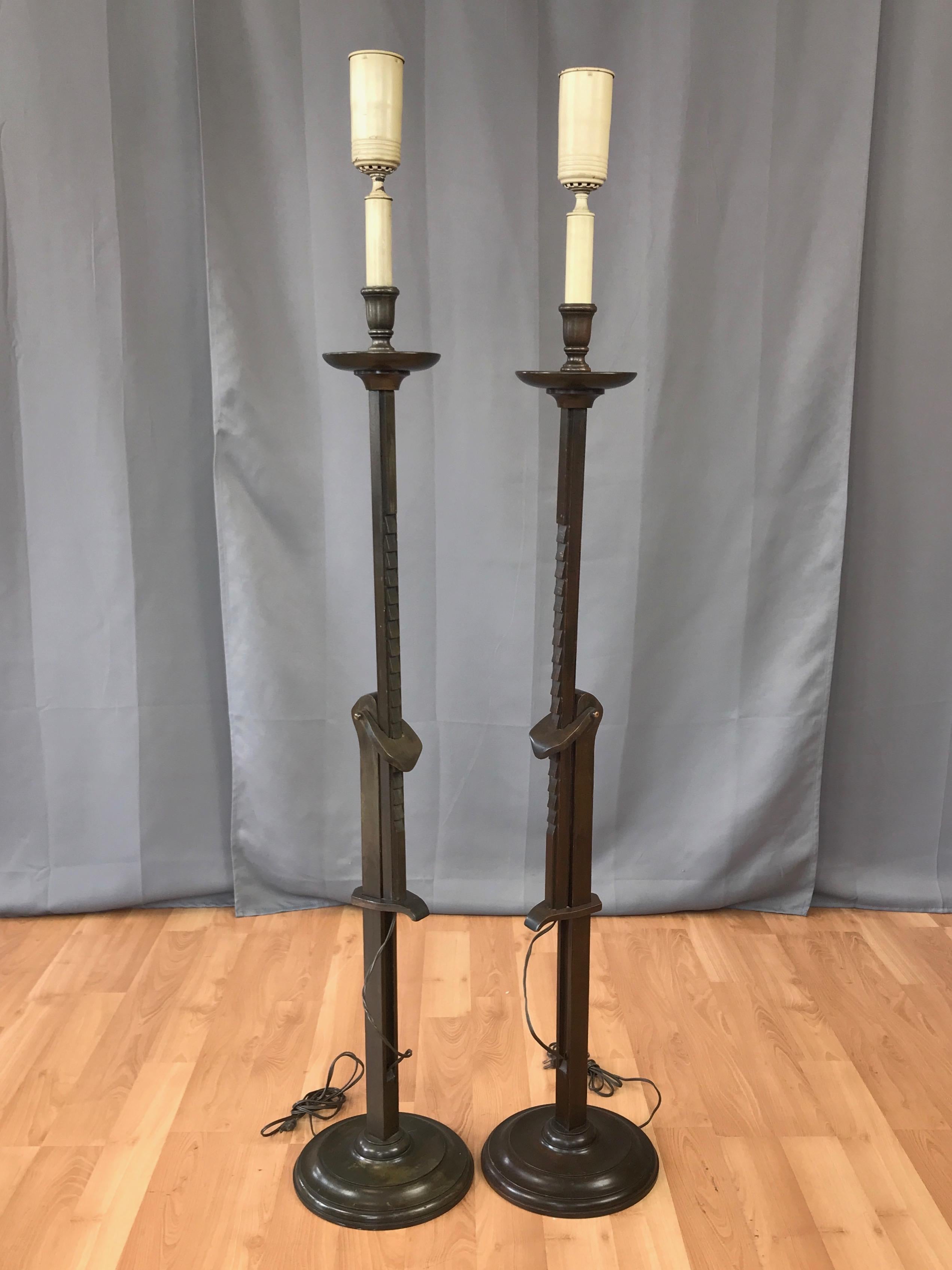 An uncommon pair of early 1940s mahogany candlestick-style adjustable height floor lamps by renowned California designer Frances Adler Elkins (b. 1888–1953).

Clever ratcheted mechanism allows for incremental adjustment from 48.5 to 64 inches