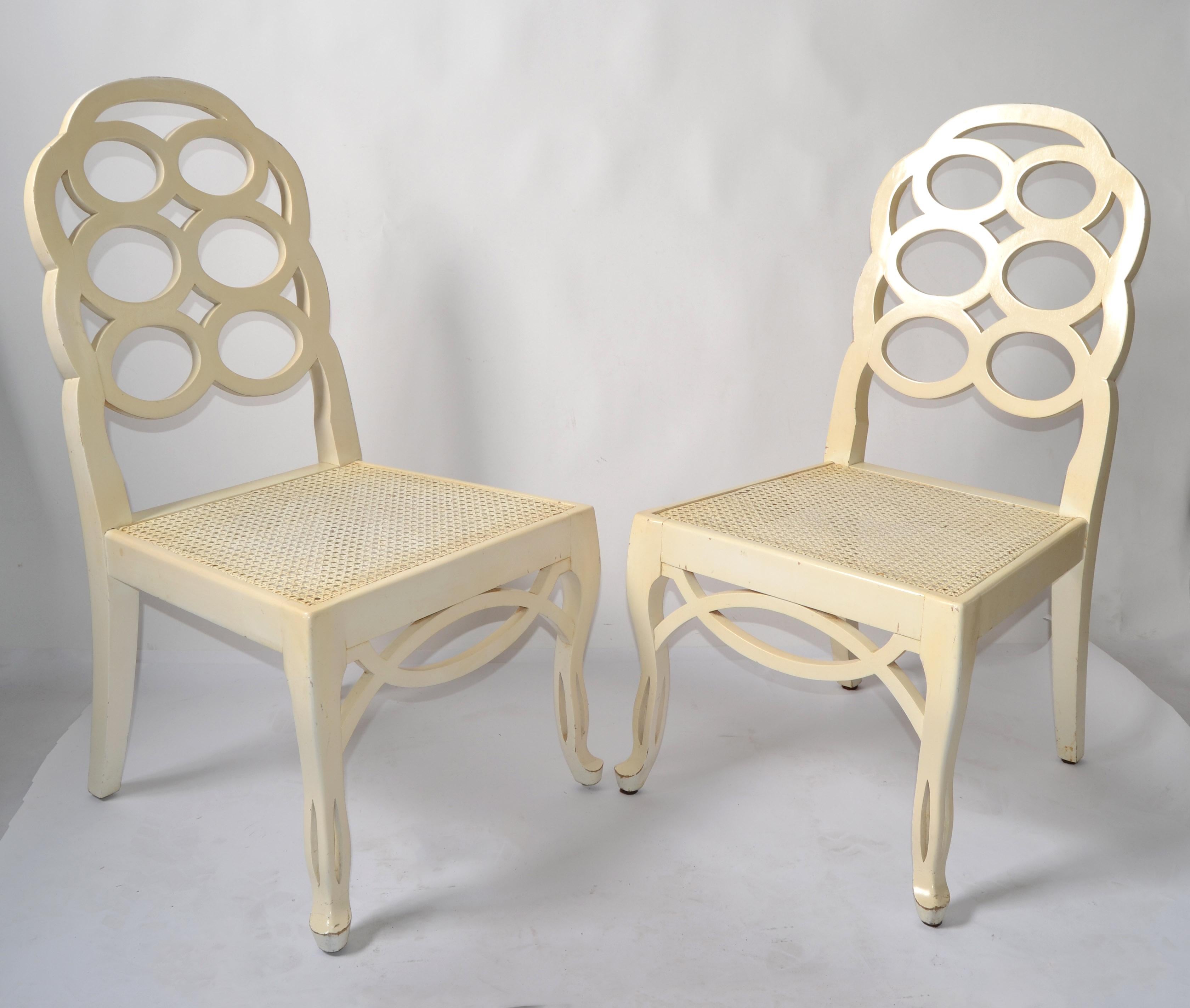 First Edition Pair of Loop Side or Dining Chairs designed by Frances Elkins and made in Spain circa 1965.
Regency Period with hand-carved legs, Apron Decoration and both are with the original handwoven caned seat.
The original beige lacquer finish