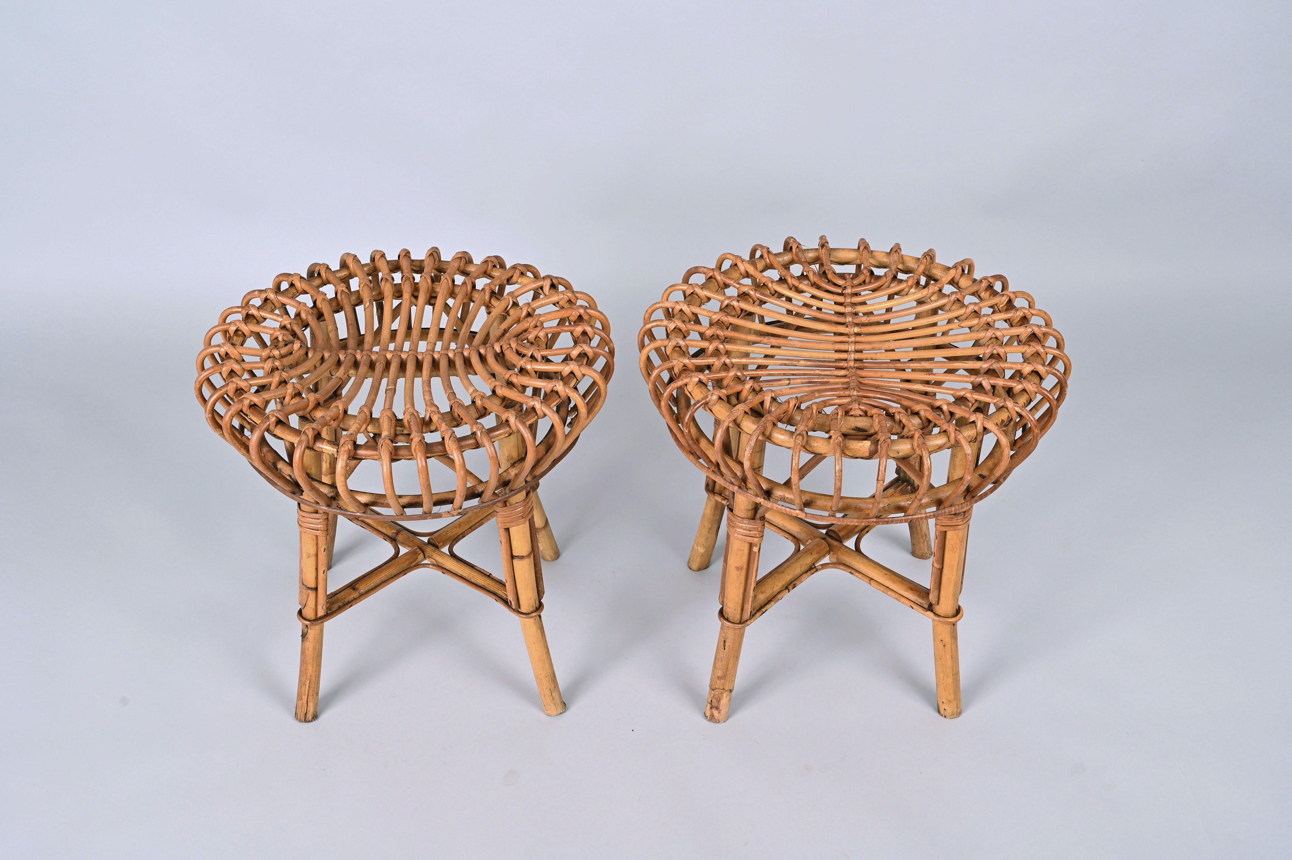 Pair of midcentury round rattan and bamboo ottoman stools. This set was designed by Franco Albini in Italy during the 1960s.

Franco Albini's extraordinary architectural ideas emerge through purity and poetry forms, mixing soft shapes with