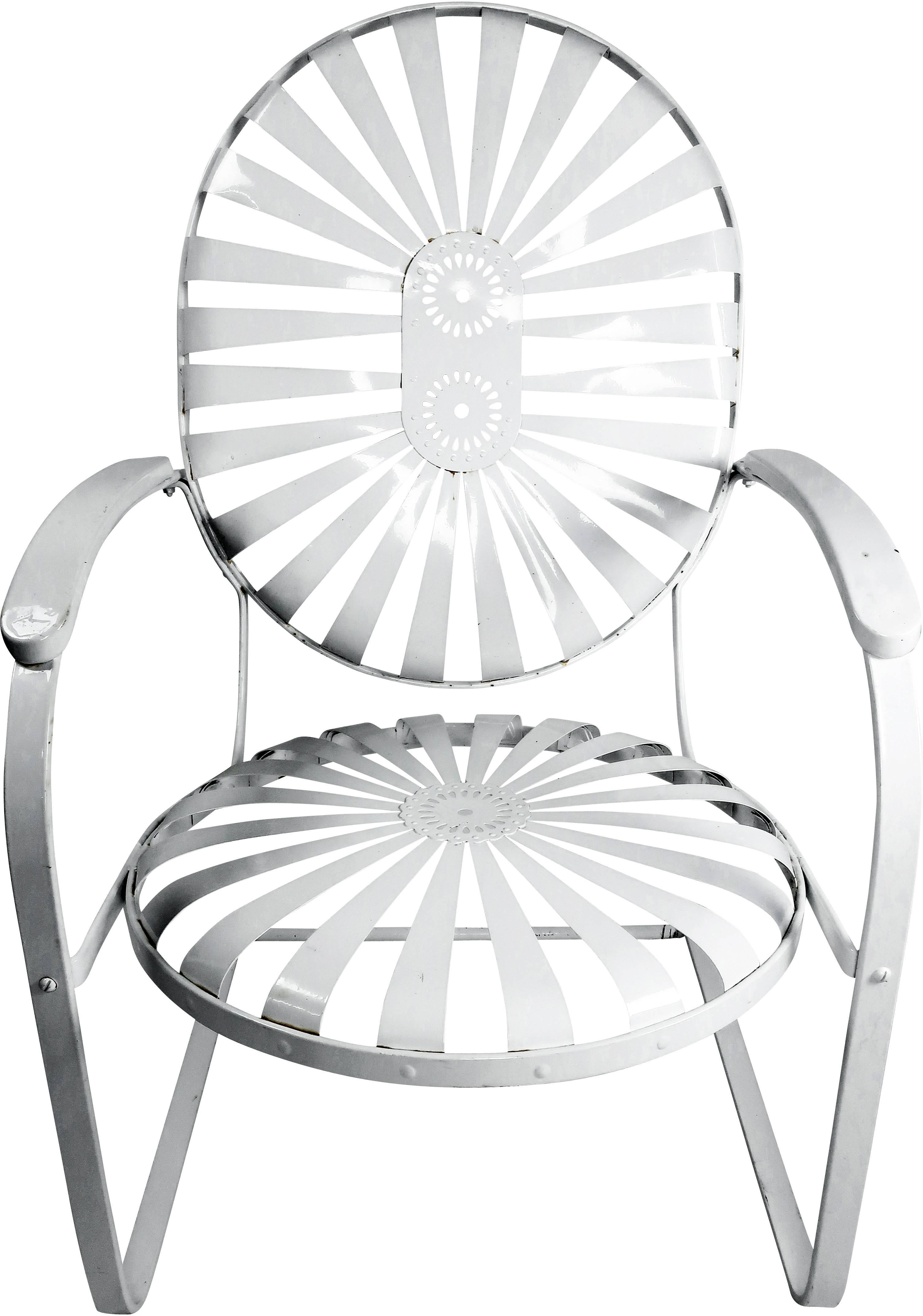 This pair of Art Deco sunburst iron garden or patio chairs were designed by Francois Carre and produced in the 1930s or 1940s. The cantilever in these arm chairs provides a satisfying and relaxing bounce. A classic design that is extremely