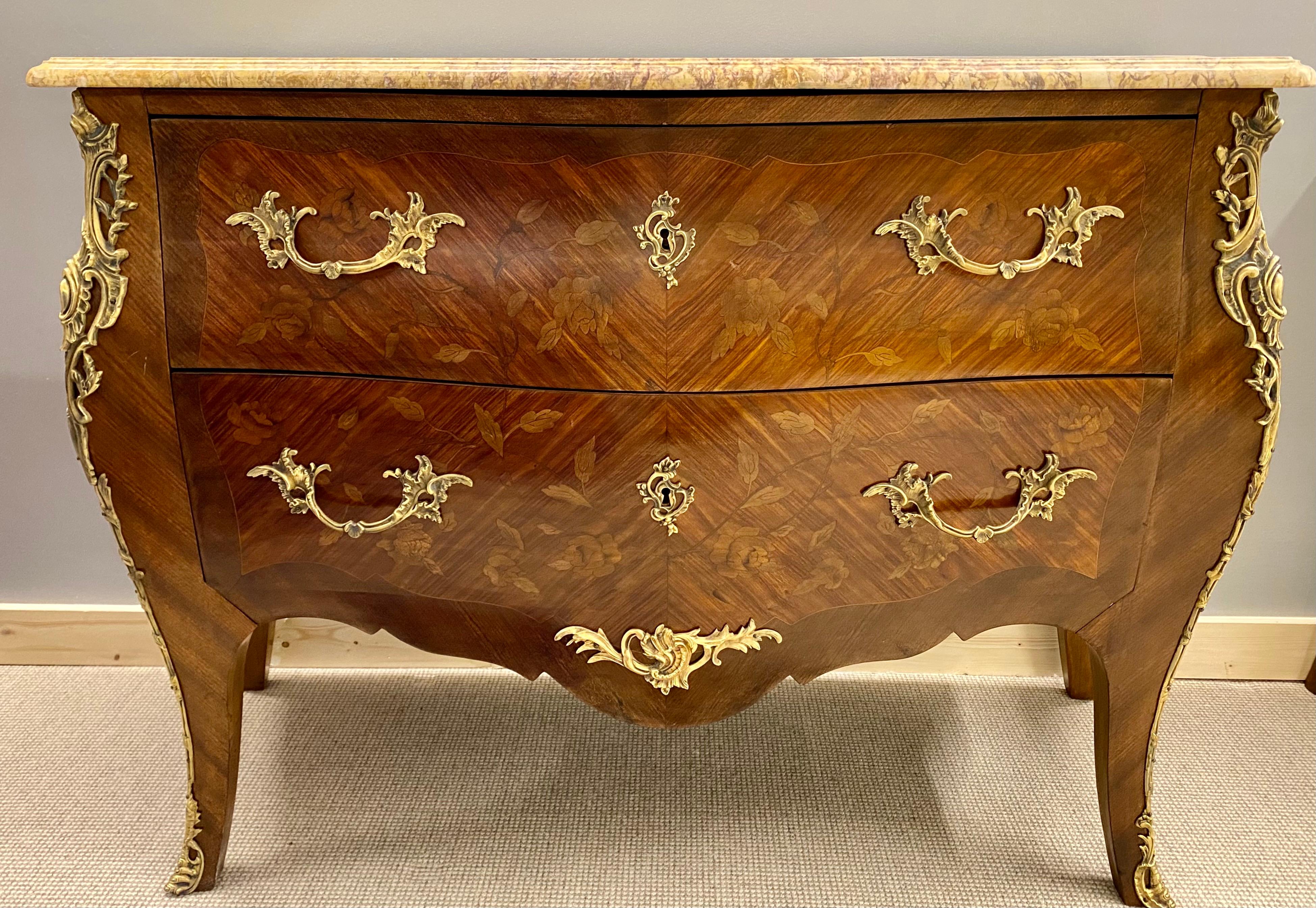 Pair of Francois Linke signed Bombe inlaid commodes nightstands. A stunning pair of floral inlaid bombe marble top commodes in the manner of Linke. Each bearing the signature on the corner bronze.