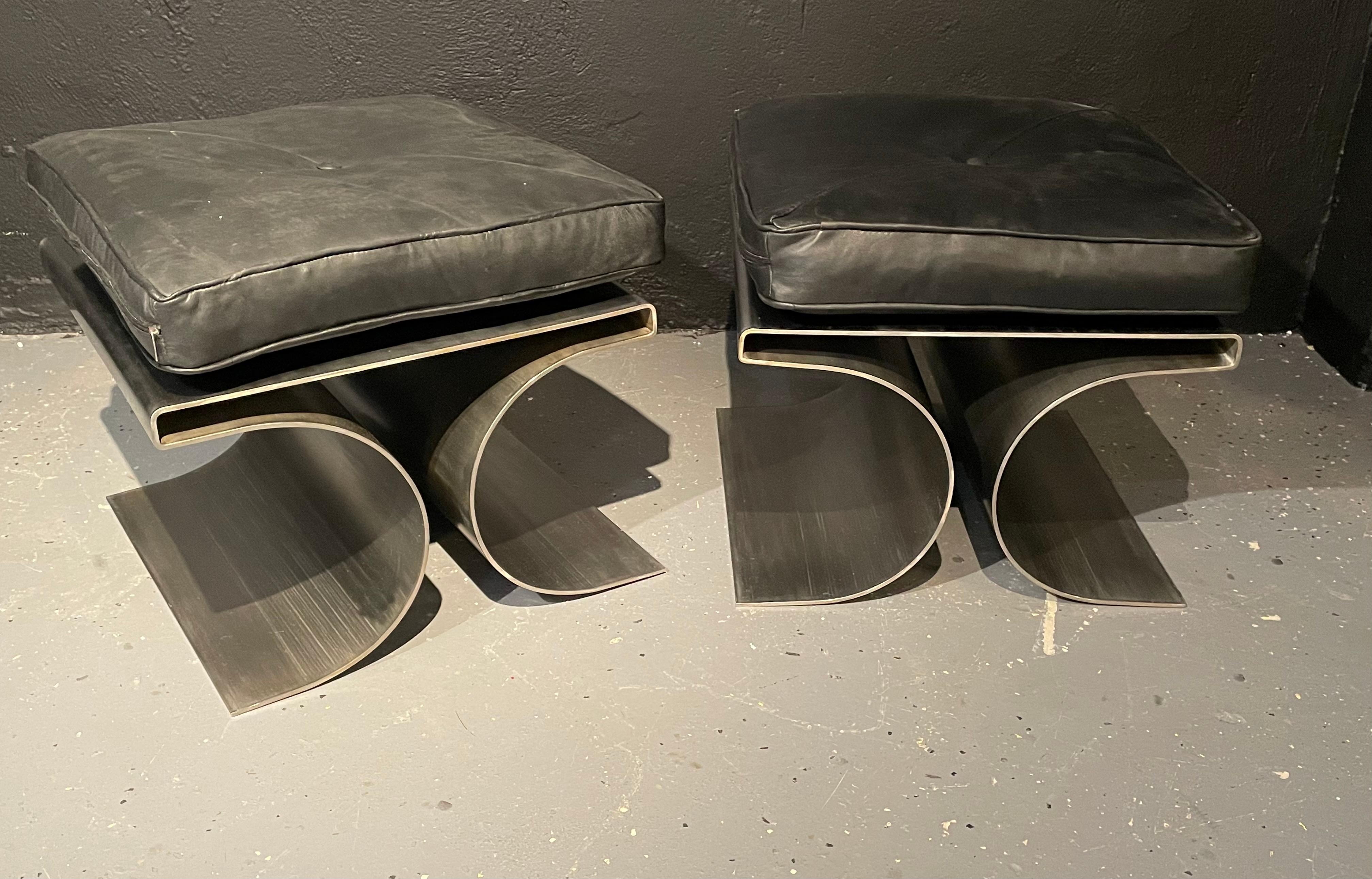 Pair of Michel Boyer Style Rouve Edition 'X' stools in a brushed stainless steel with a black leather cushion. These impressive Mid-Century Modern benches are simply stunning. The strong heavy and sturdy bases having the 'X' form with a flat top