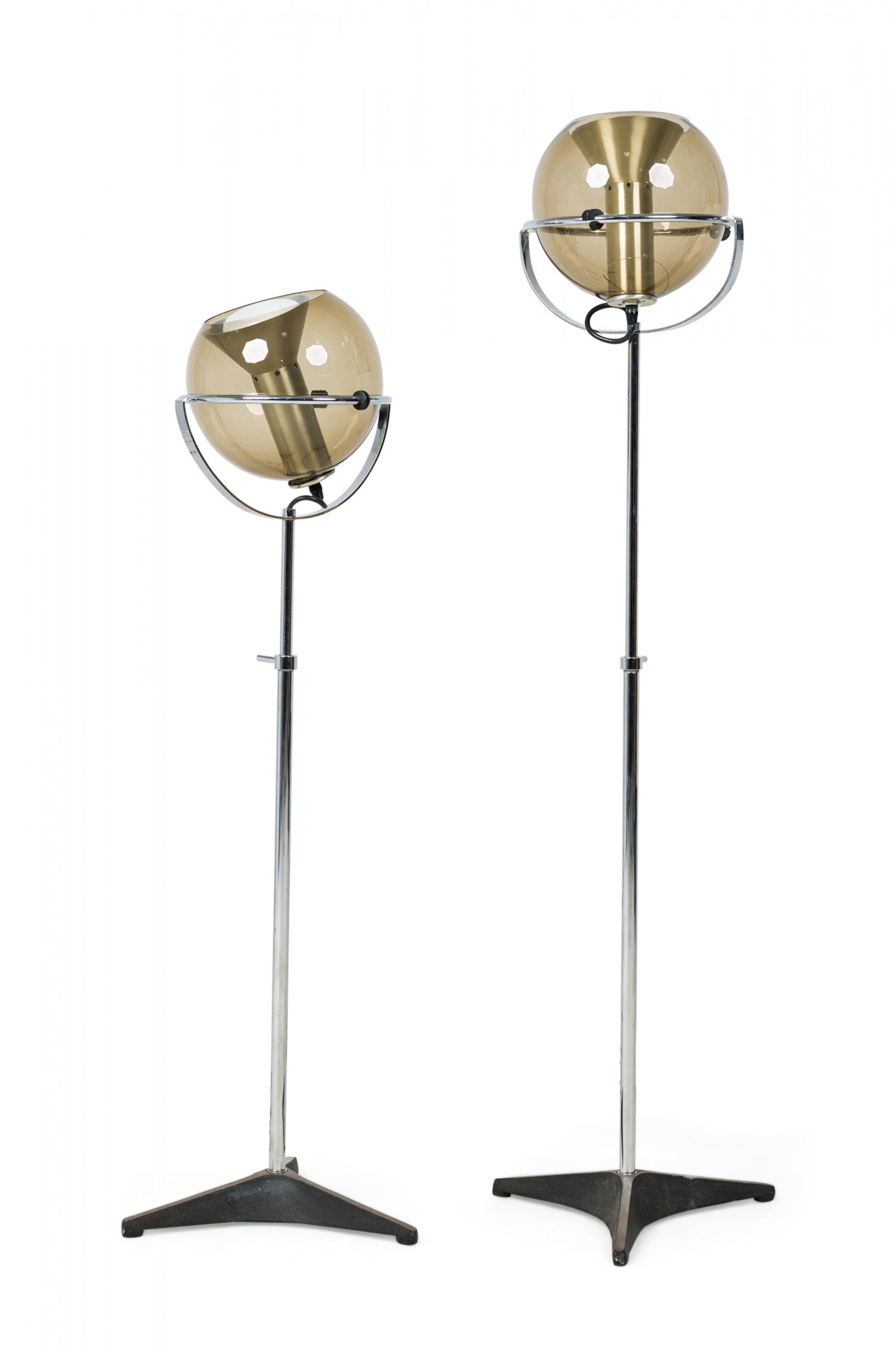 PAIR of midcentury Dutch Modern (1960s) floor lamps with smoked glass globes mounted on a silver metal adjustable height stands and triangular bases (Frank Ligtelijn FOR RAAK) (PRICED AS PAIR).