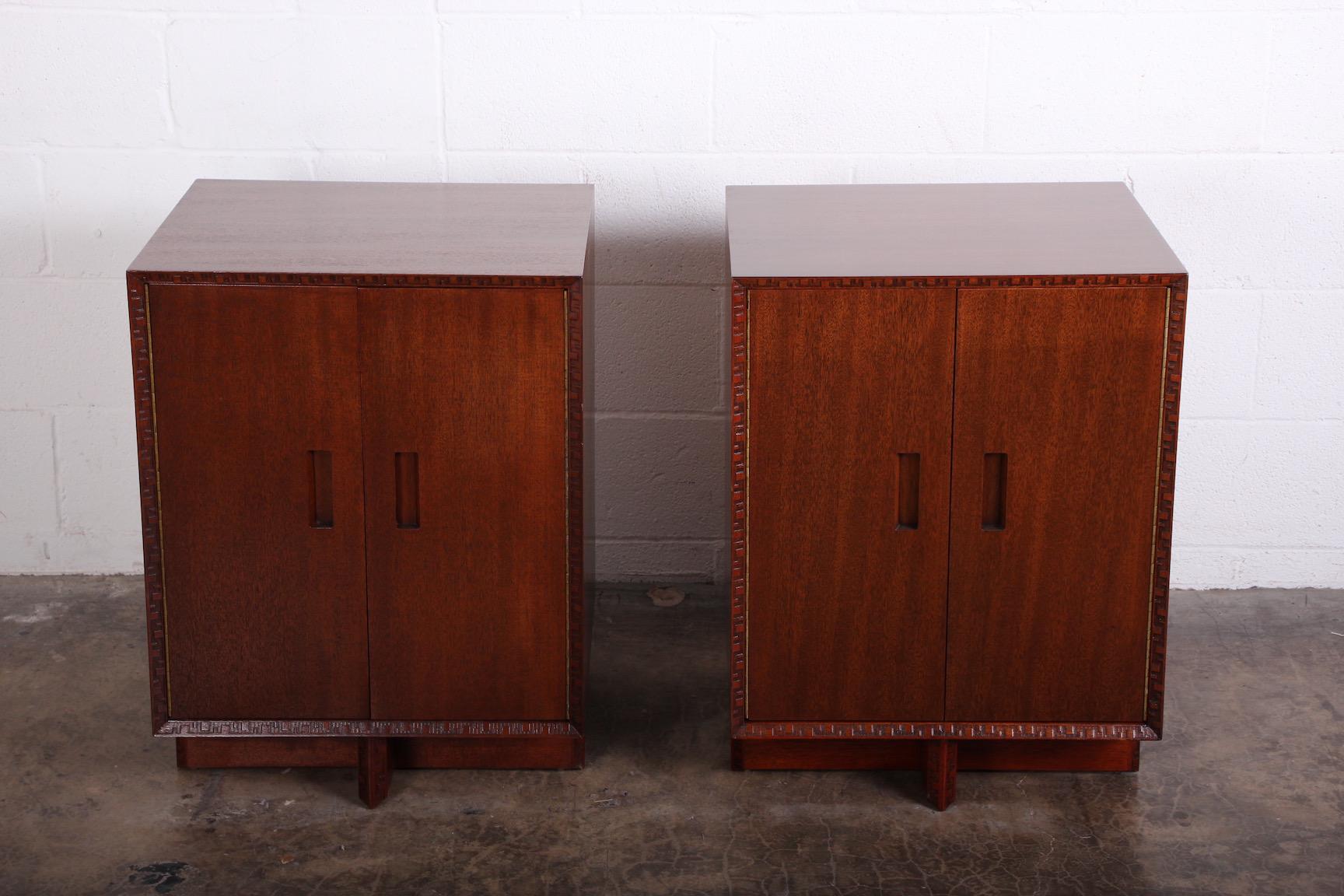 A pair of mahogany cabinets / nightstands by Frank Lloyd Wright for Henredon.