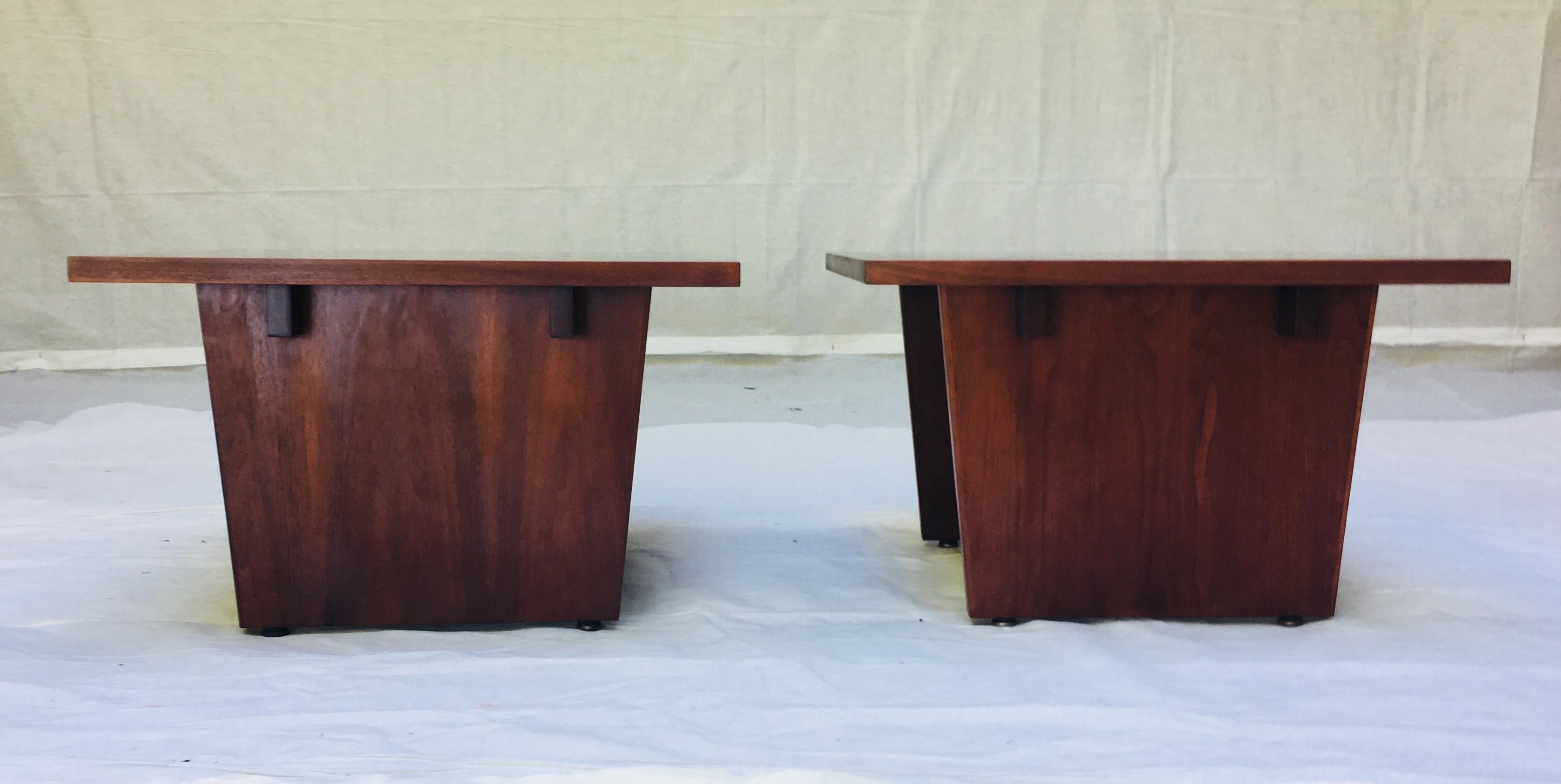 A pair of side tables by California Modern furniture craftsman Frank Rohloff. 
The table tops are black resin with pieces of walnut veneer set in the black resin creating a dynamic juxtaposition of materials bordered by a walnut outer edge.
The