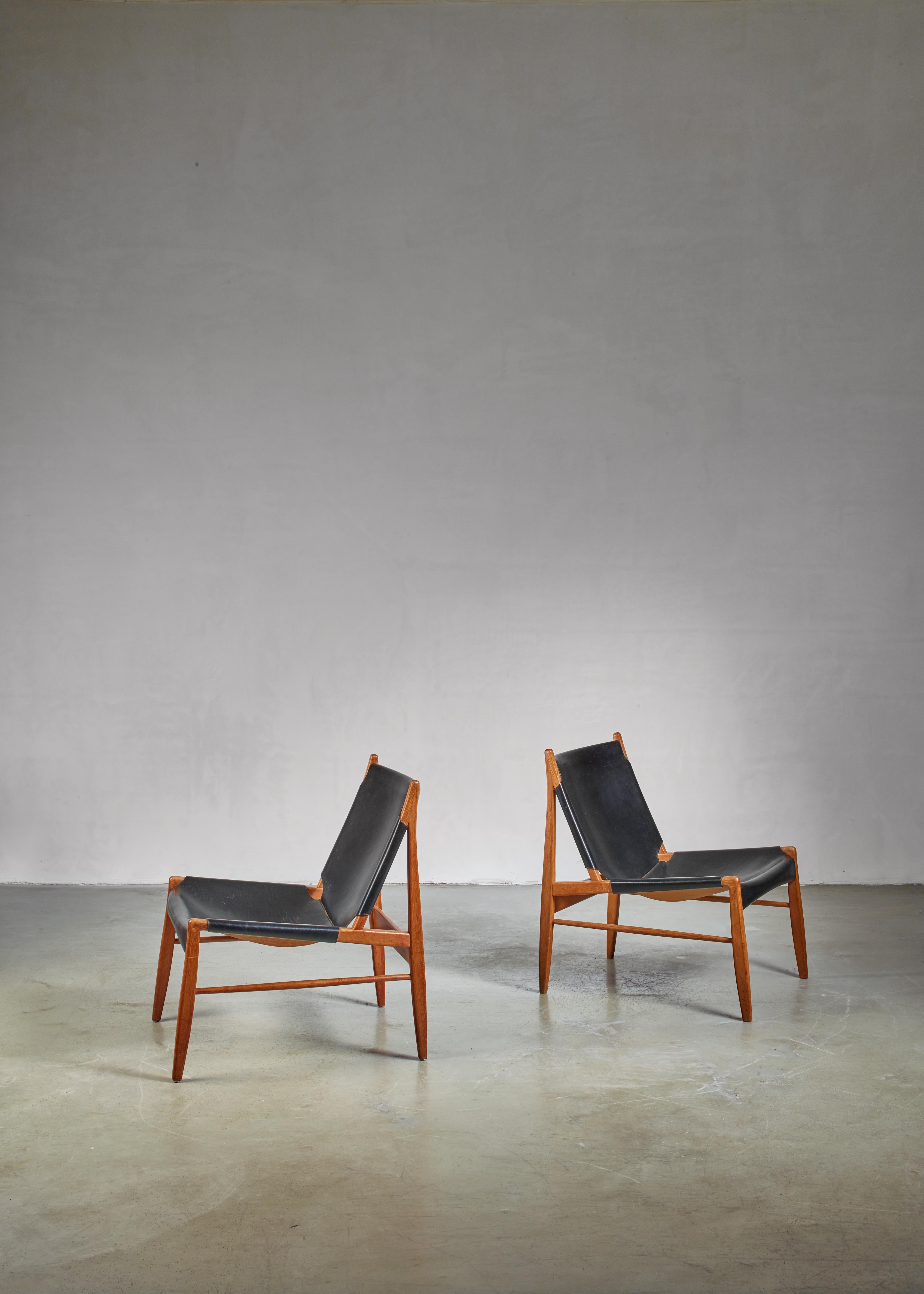 A pair of 'Hunting' lounge chairs by Franz Xaver Lutz for WK Möbel. These Hunting or Chimney chairs slope slightly backwards for a relaxing posture and as their name indicates, they are often positioned close to the fire place. 
The price is per