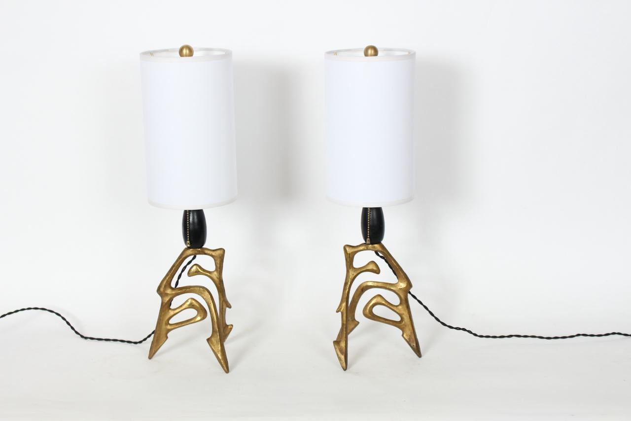 Pair of early Frederic Weinberg Abstract Dancer Bronze Table Lamps. Featuring figurative, open, solid cast Bronze designs with Black enameled oval wooden necks and newly replaced custom White Linen (6D x 10H) lampshades. Original patina. 22H to top