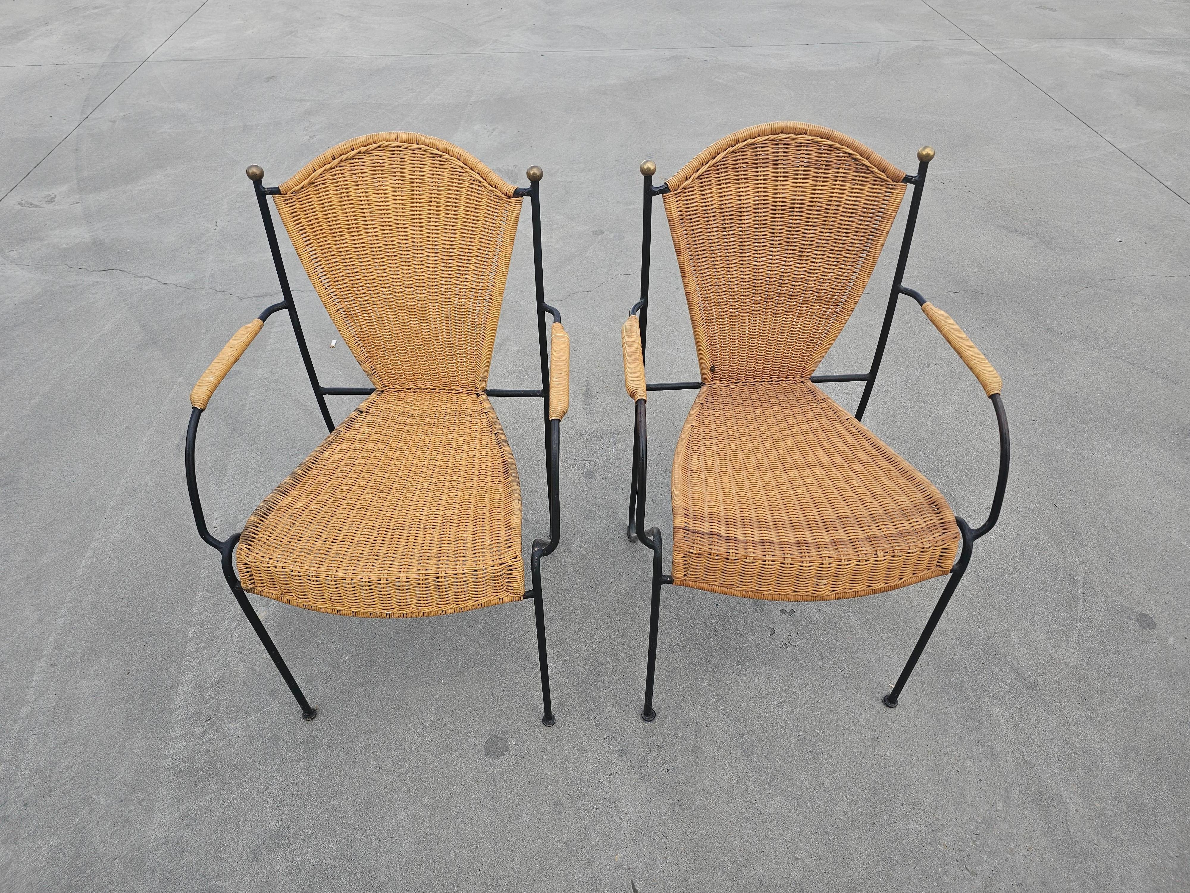 In this listing you will find a set of Mid-Century Modern chairs designed by Frederic Weinberg, the renowned US designer. Chairs are made of wrought iron and wicker, with brass details on the backrests, which makes them stand out. 

Chairs are in