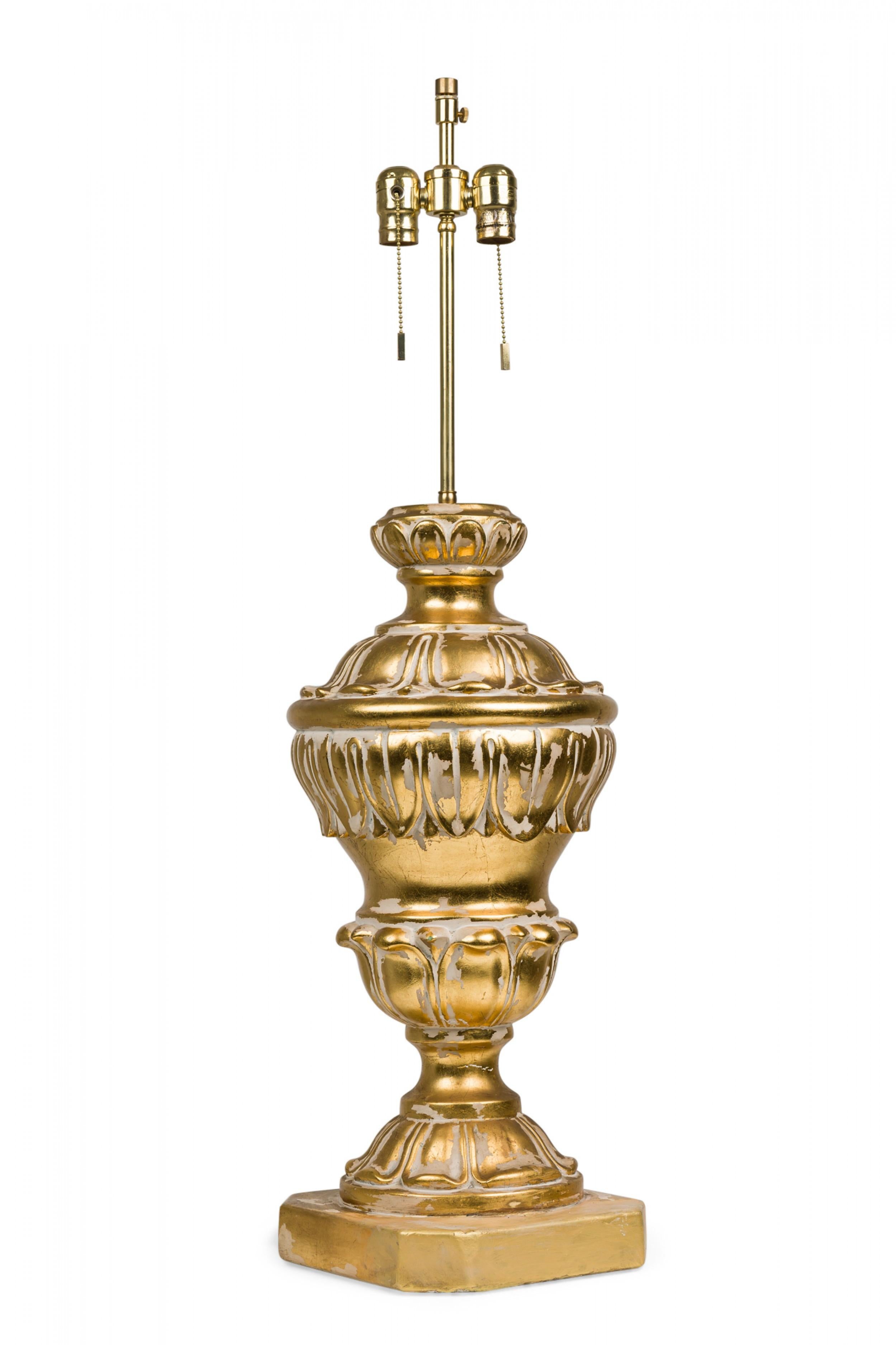 PAIR of midcentury American cast plaster table lamps in elaborate baluster form, both with extended brass stems and functioning beaded light switch sockets, molded in neoclassic scroll form with painted parcel gilt highlights in an antiqued distress
