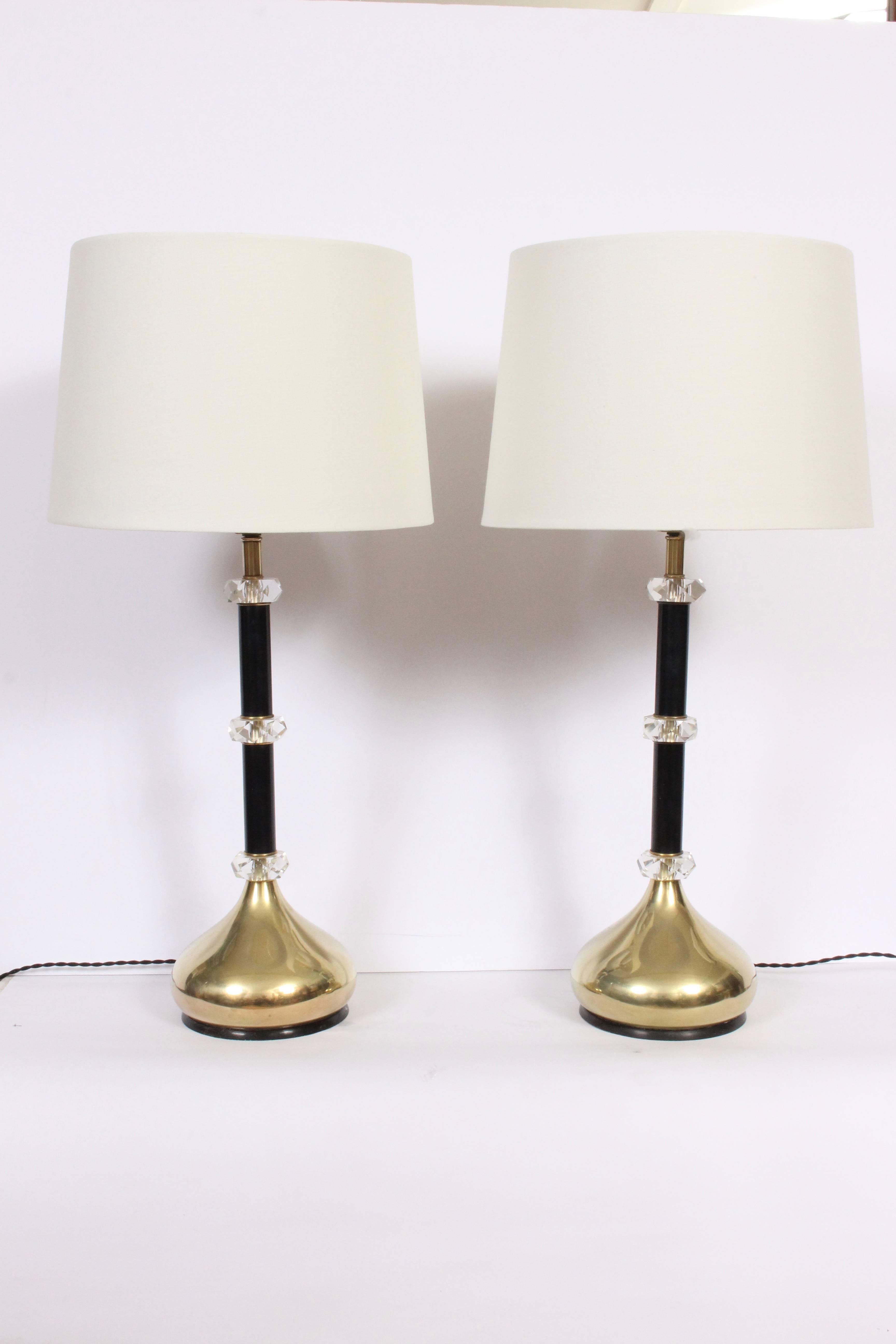 Large pair of Atomic Regency Frederick Cooper attributed Brass, Black enamel and faceted Lucite crystal stacked Table Lamps. Featuring Black enamel stems, three faceted Lucite crystals with rounded genie  Brass base. Hollywood Regency. Elegant.