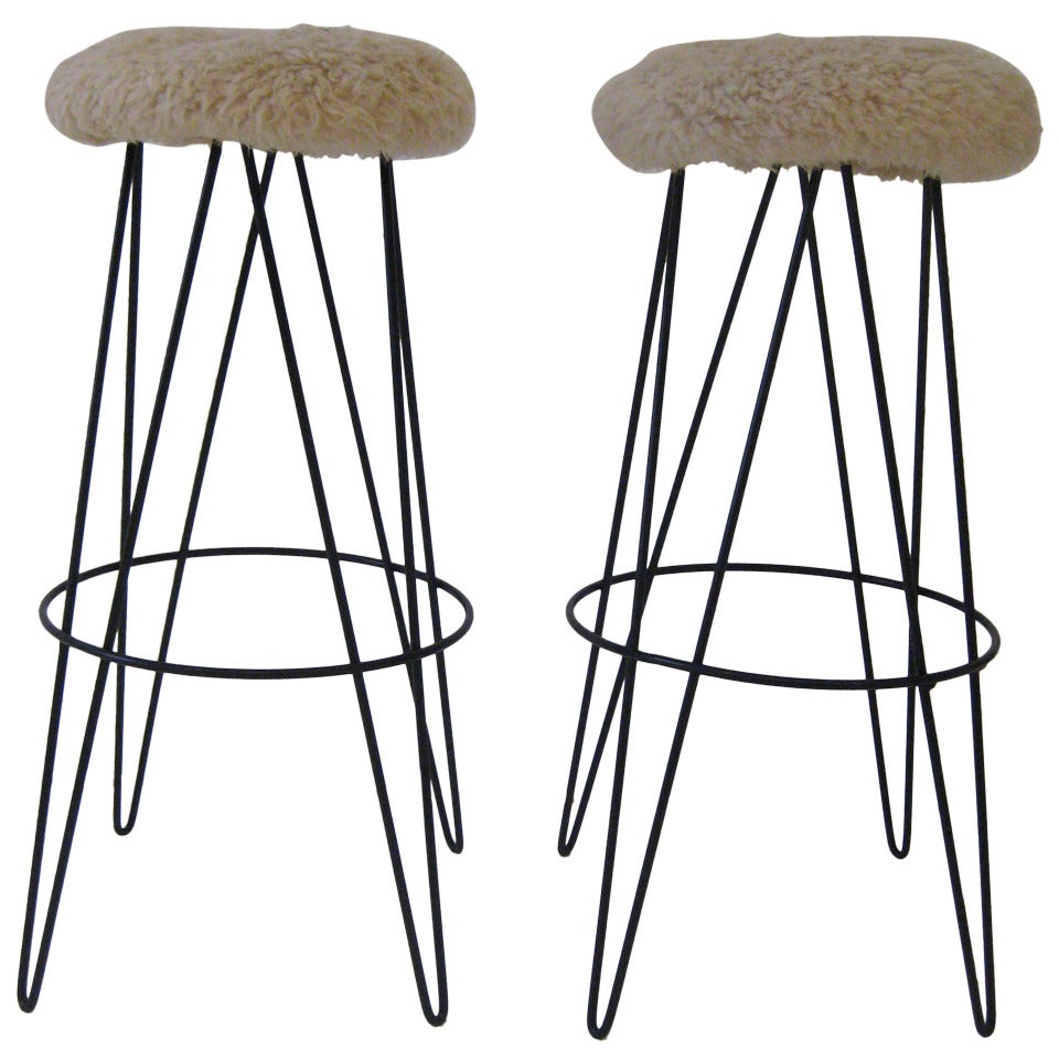 Enameled iron butterfly hairpin legs with sheepskin seats.