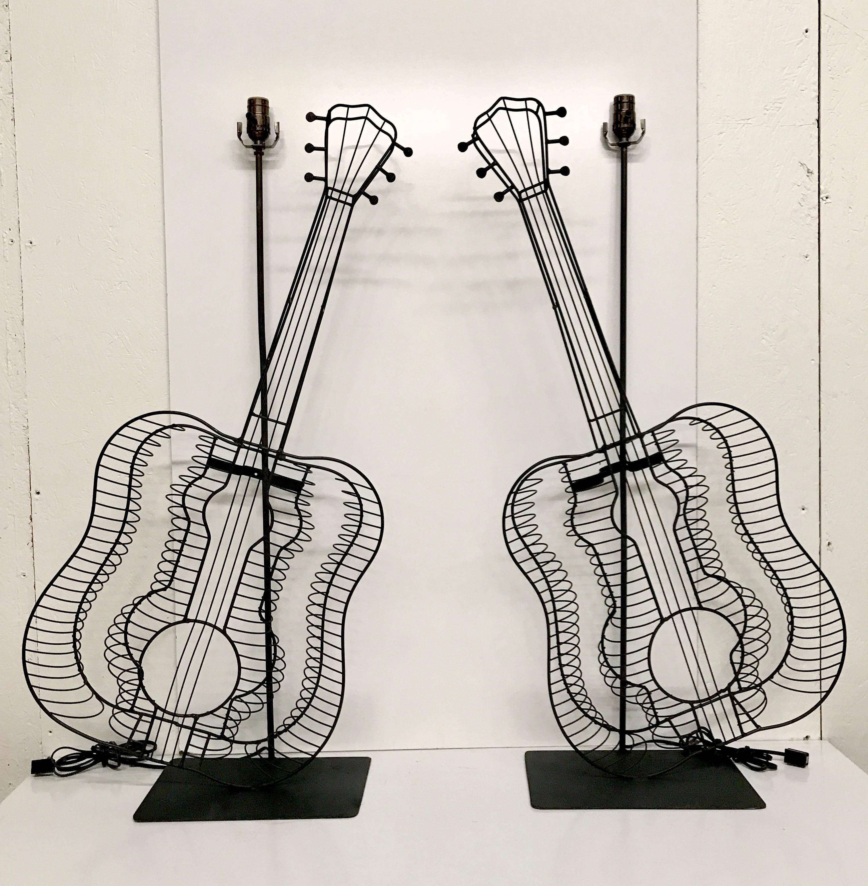 A pair of Fredrick Weinberg style guitar lamps, one facing right the other facing left. The actual sculptures measure 38 inches high x 4 inches deep.