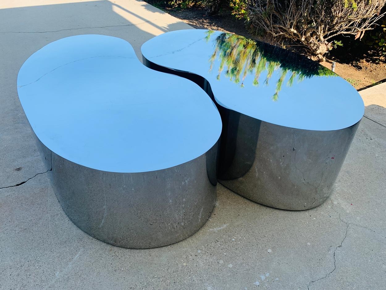 Stunning pair of free-form coffee tables in stainless steel. The tables have beautiful lines, and they can be used separetly or next to each other as they fit well next to each other.

Measurements:
Lower table.
60 inches wide x 30 inches deep x