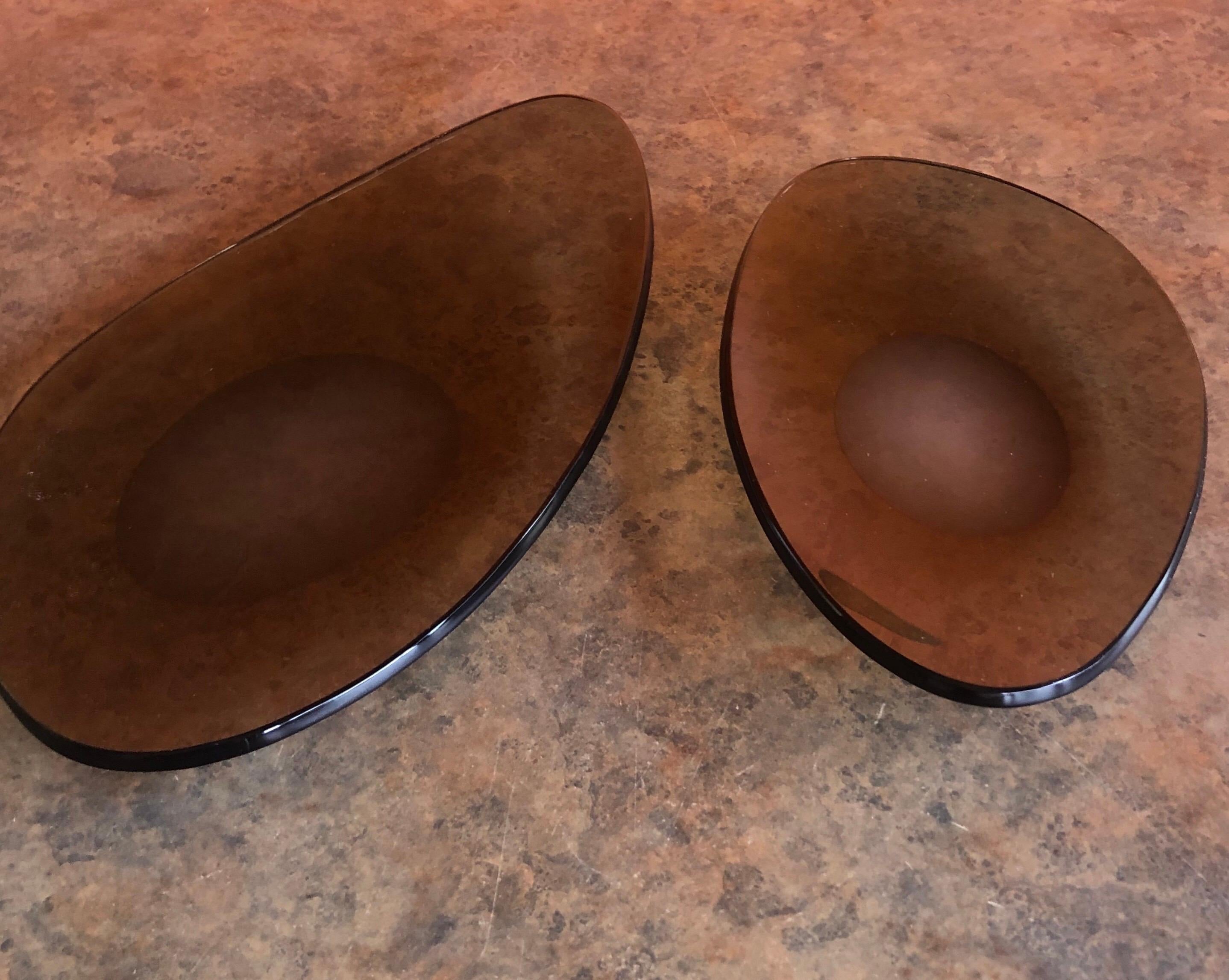 A very nice pair of shallow freeform sculptural smoke glass bowls, circa 1970s. The bowls are in very good vintage condition and measure as follows: Large 11.25 W x 6.5