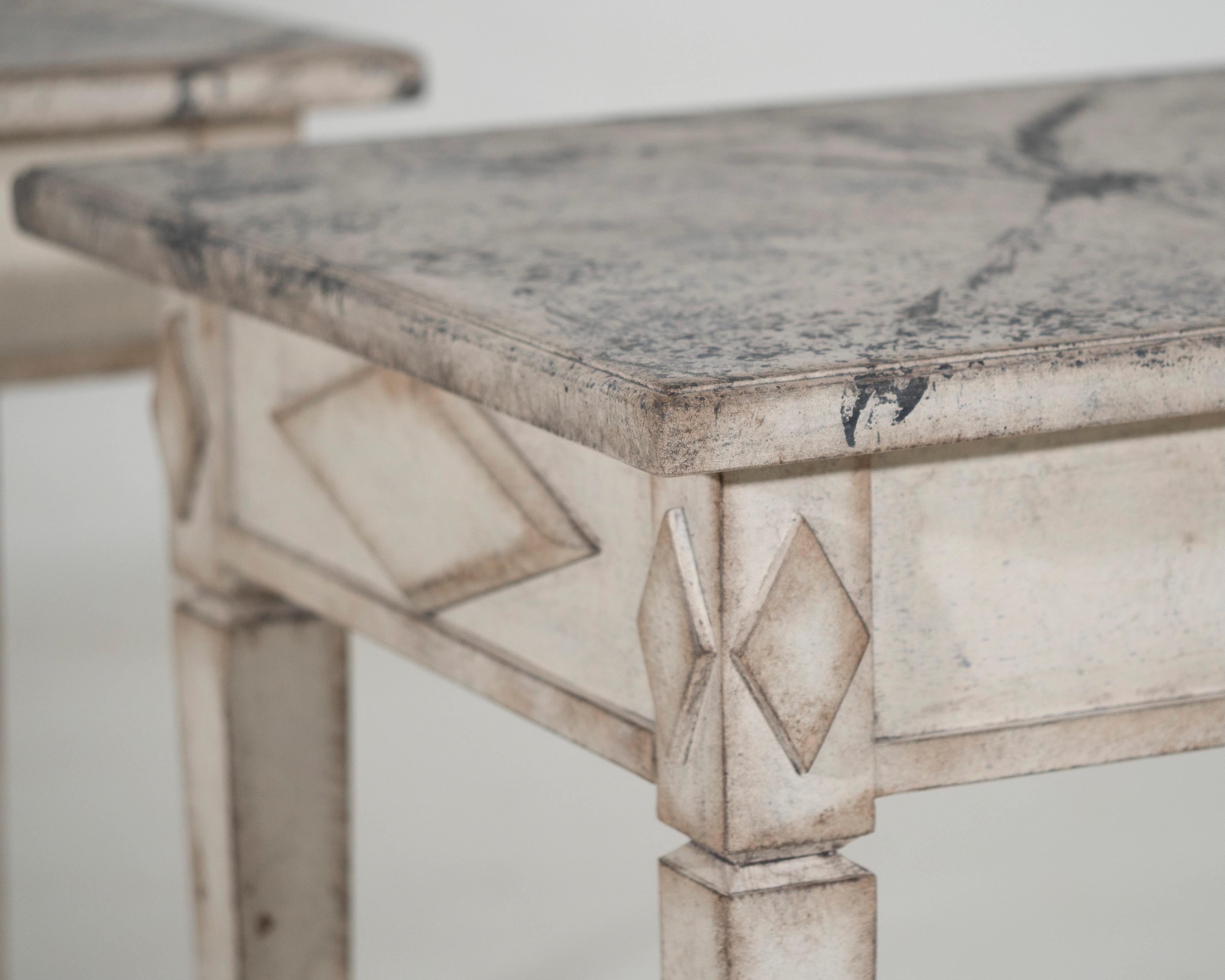 Pair of freestanding Gustavian style console tables, with faux painted marble top and fine decorations on the sides, 20th Century.