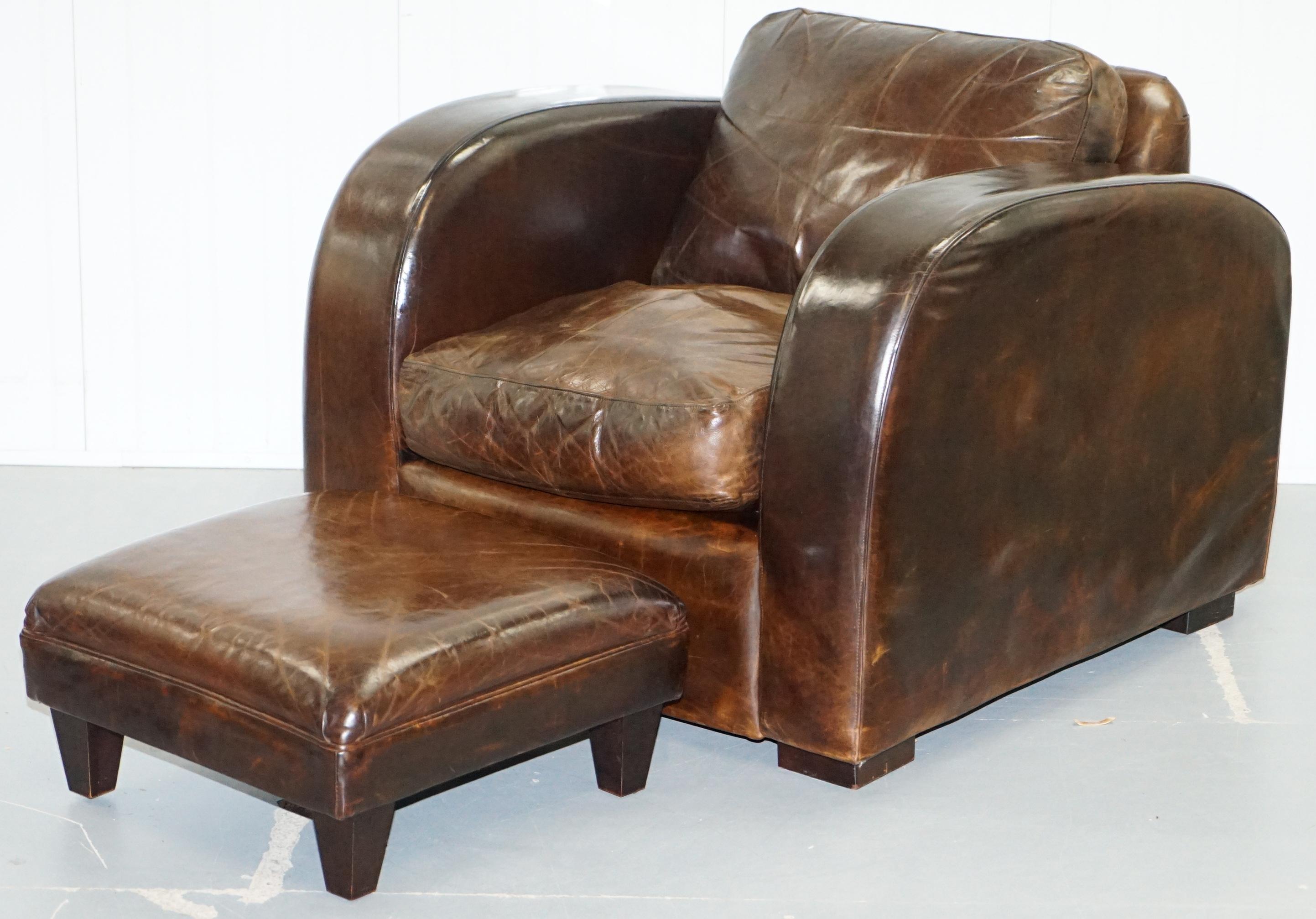 We are delighted to offer for sale this lovely set of original handmade in London pair of hand dyed brown leather club armchairs and footstools by Freestyle London LTD.

An extremely stylish and comfortable pair, the lines look very Art Deco with