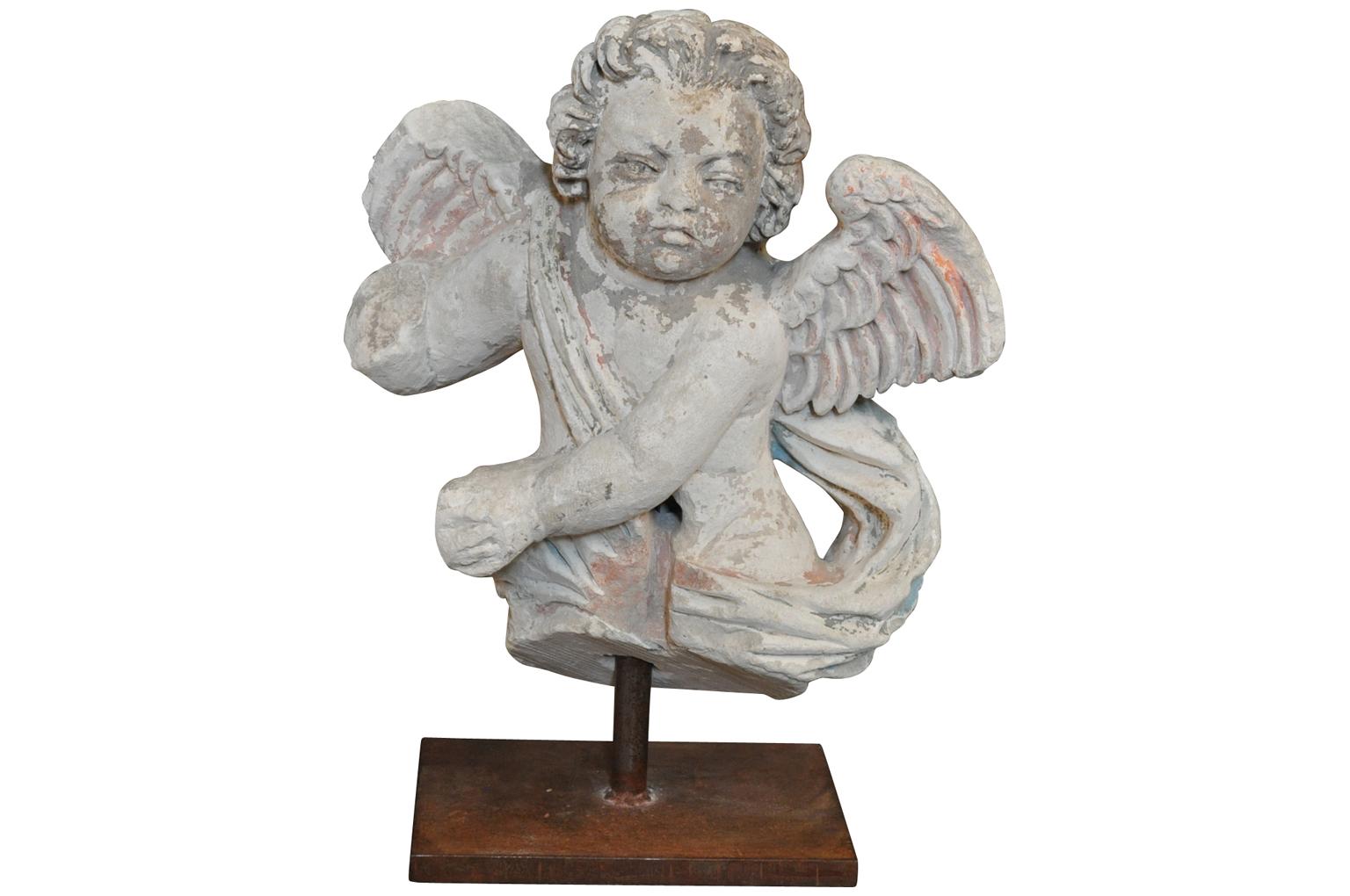 A wonderful pair of French 15th century carved stone angels statues presented on iron supports. The bases measure 3/4
