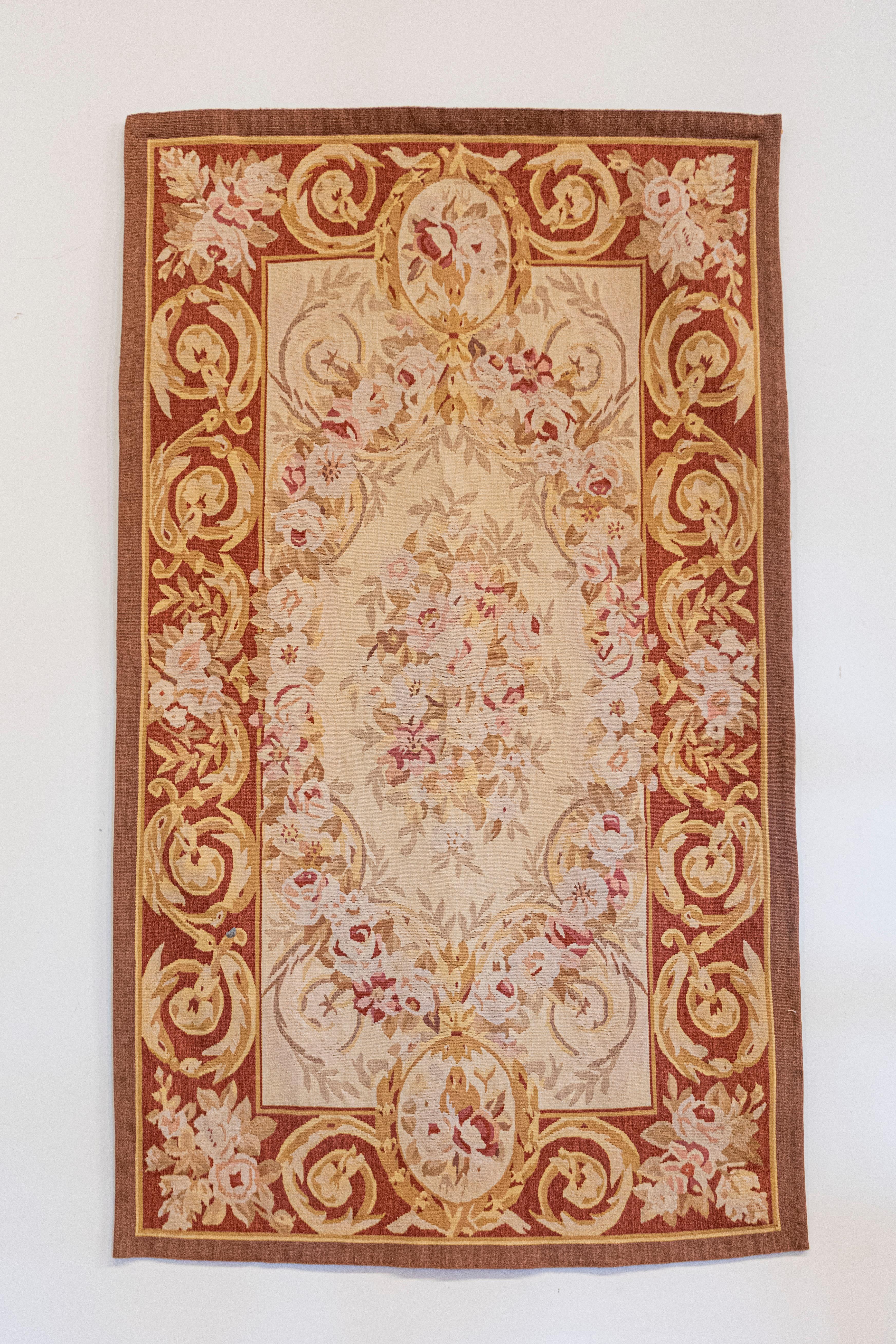 A pair of French Napoleon III period Aubusson tapestries from the mid-19th century depicting rinceaux surrounding a floral decor. Woven in the famous Aubusson Manufacture located in central France during the 1850s, each of this pair of wall