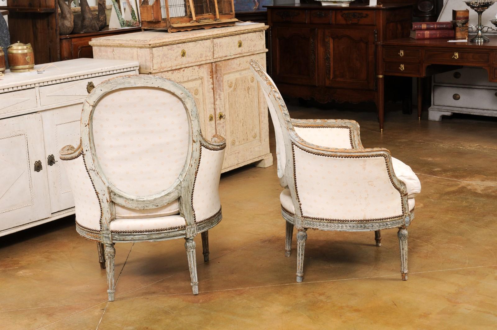 Pair of French 1850s Louis XVI Style Painted Bergère Chairs with Carved Décor 4
