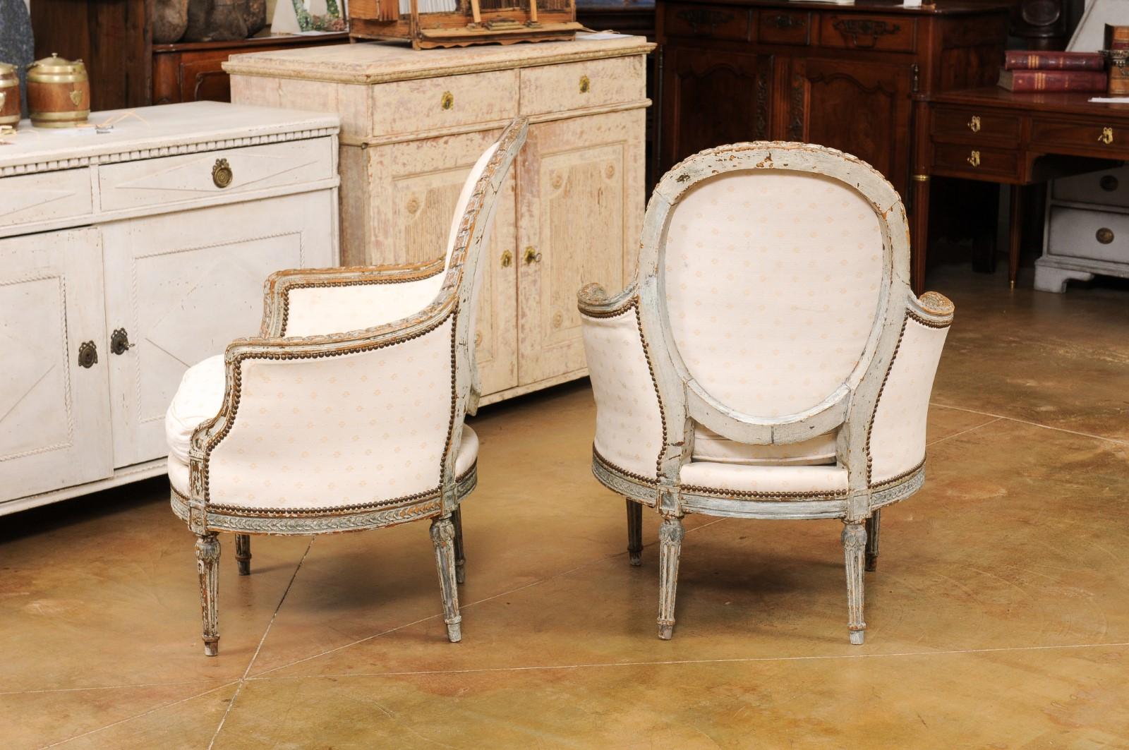 Pair of French 1850s Louis XVI Style Painted Bergère Chairs with Carved Décor 6
