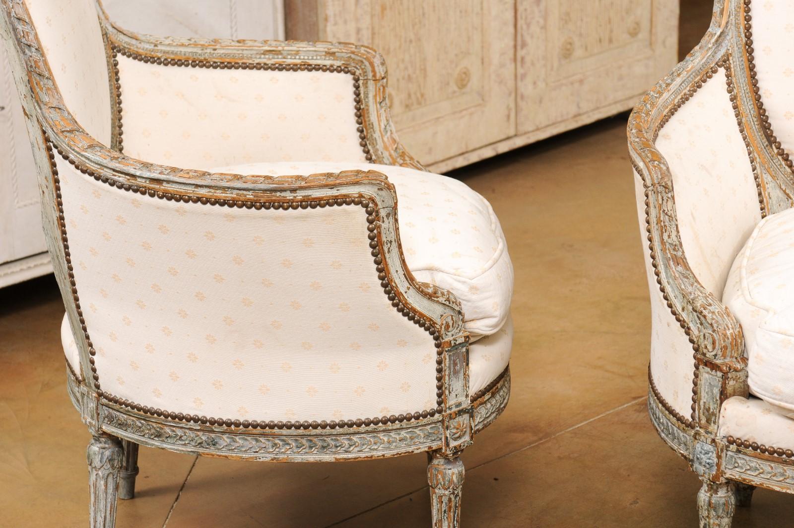Pair of French 1850s Louis XVI Style Painted Bergère Chairs with Carved Décor 1