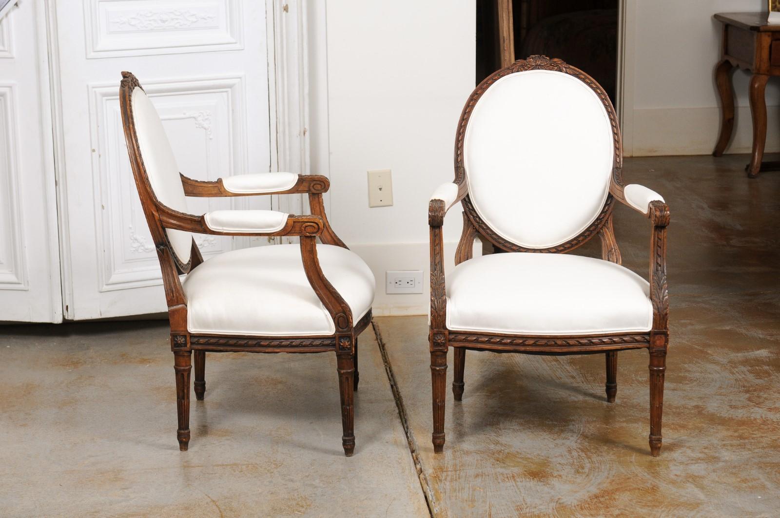 Pair of French 1850s Louis XVI Style Walnut Oval Back Upholstered Armchairs In Good Condition For Sale In Atlanta, GA