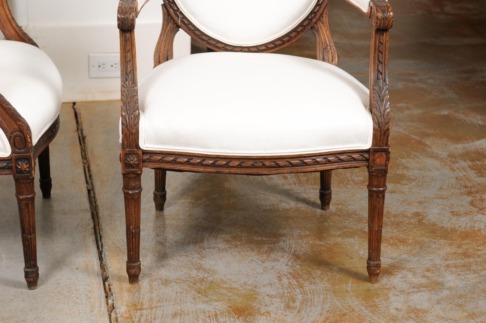 19th Century Pair of French 1850s Louis XVI Style Walnut Oval Back Upholstered Armchairs For Sale