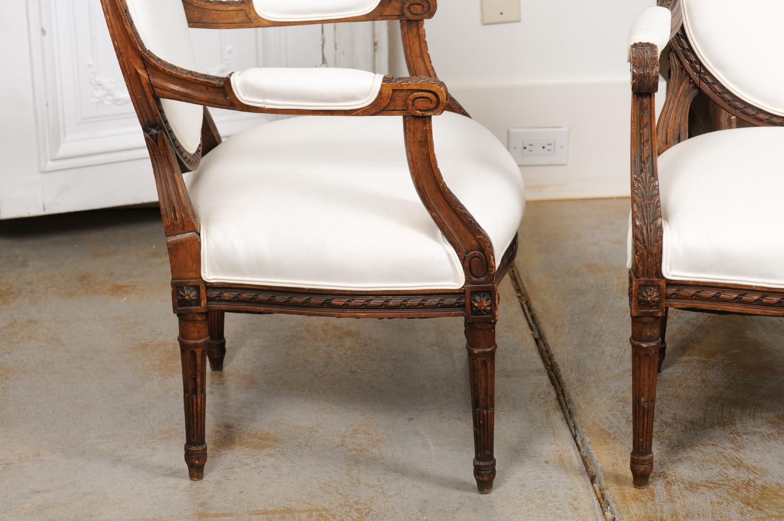 Upholstery Pair of French 1850s Louis XVI Style Walnut Oval Back Upholstered Armchairs For Sale
