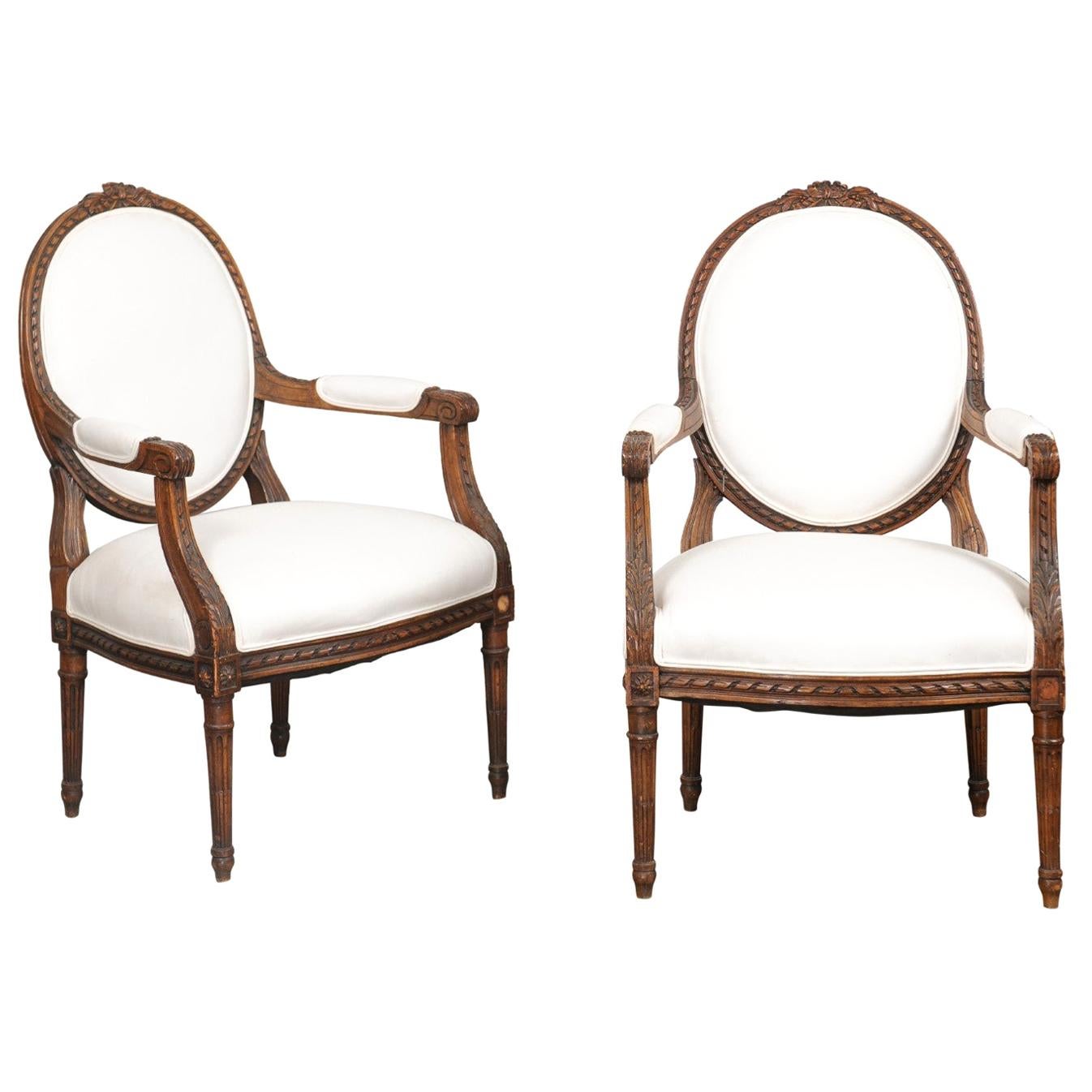 Pair of French 1850s Louis XVI Style Walnut Oval Back Upholstered Armchairs