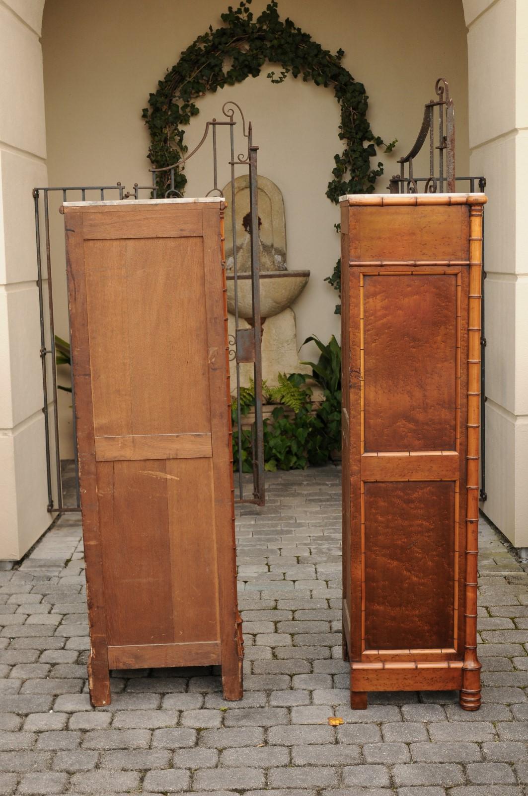 A pair of French faux bamboo and burl wood semainiers from the second quarter of the 19th century, with conforming marble tops and geometric design. Born at the end of the reign of France's last Emperor Napoleon III, each of this pair of tall and